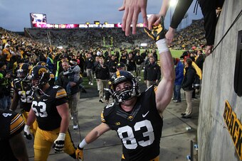 IOWA CITY, IA - OCTOBER 31:  Wide receiver Riley McCarron #83 of the Iowa Hawkeyes celebrates with fans after the match-up against the Maryland Terrapins on October 31, 2015 at Kinnick Stadium, in Iowa City, Iowa.  (Photo by Matthew Holst/Getty Images)