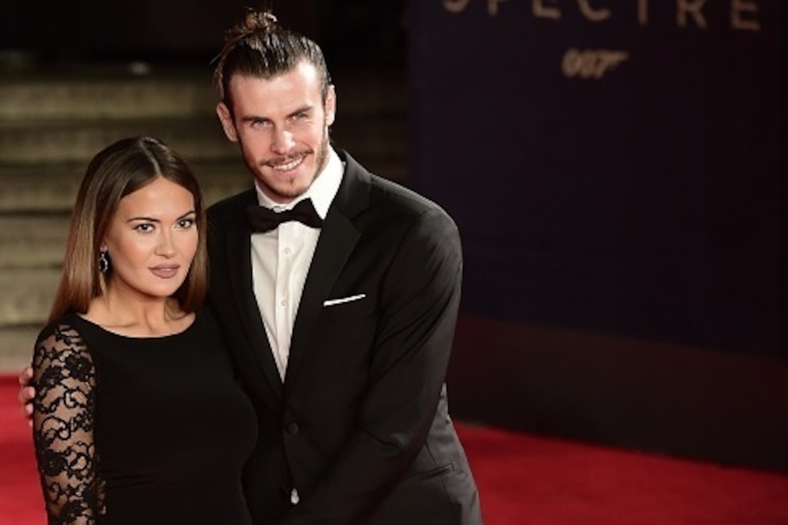 Welsh footballer Gareth Bale (R) and his partner Emma Rhys Jones pose on arrival for the world premiere of the new James Bond film 'Spectre' at the Royal Albert Hall in London on October 26, 2015. The film is directed by Sam Mendes and sees Daniel Craig p