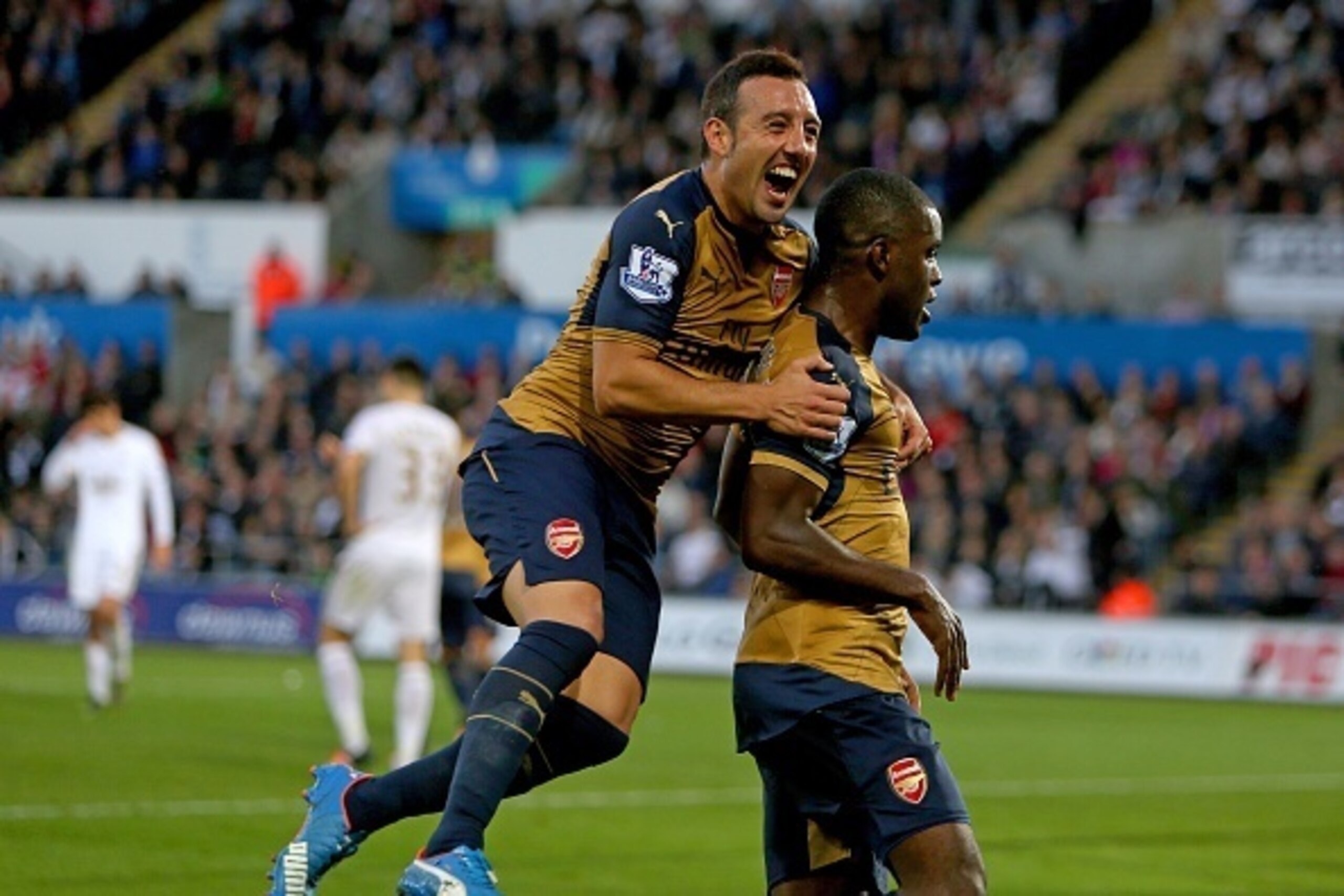 Arsenal's Costa Rican striker Joel Campbell (R) celebrates with Arsenals Spanish midfielder Santi Cazorla after scoring their third goal during the English Premier League football match between Swansea City and Arsenal at The Liberty Stadium in Swansea, s Arsenal's Costa Rican striker Joel Campbell (R) celebrates with Arsenals Spanish midfielder Santi Cazorla after scoring their third goal during the English Premier League football match between Swansea City and Arsenal at The Liberty Stadium in Swansea, s
