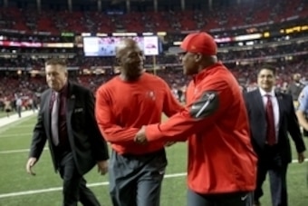 Nov 1, 2015; Atlanta, GA, USA; Tampa Bay Buccaneers head coach Lovie Smith, center, celebrates their win with cornerbacks coach Gill Byrd after their game against the Atlanta Falcons at the Georgia Dome. The Buccaneers won 23-20 in overtime. Mandatory Cre