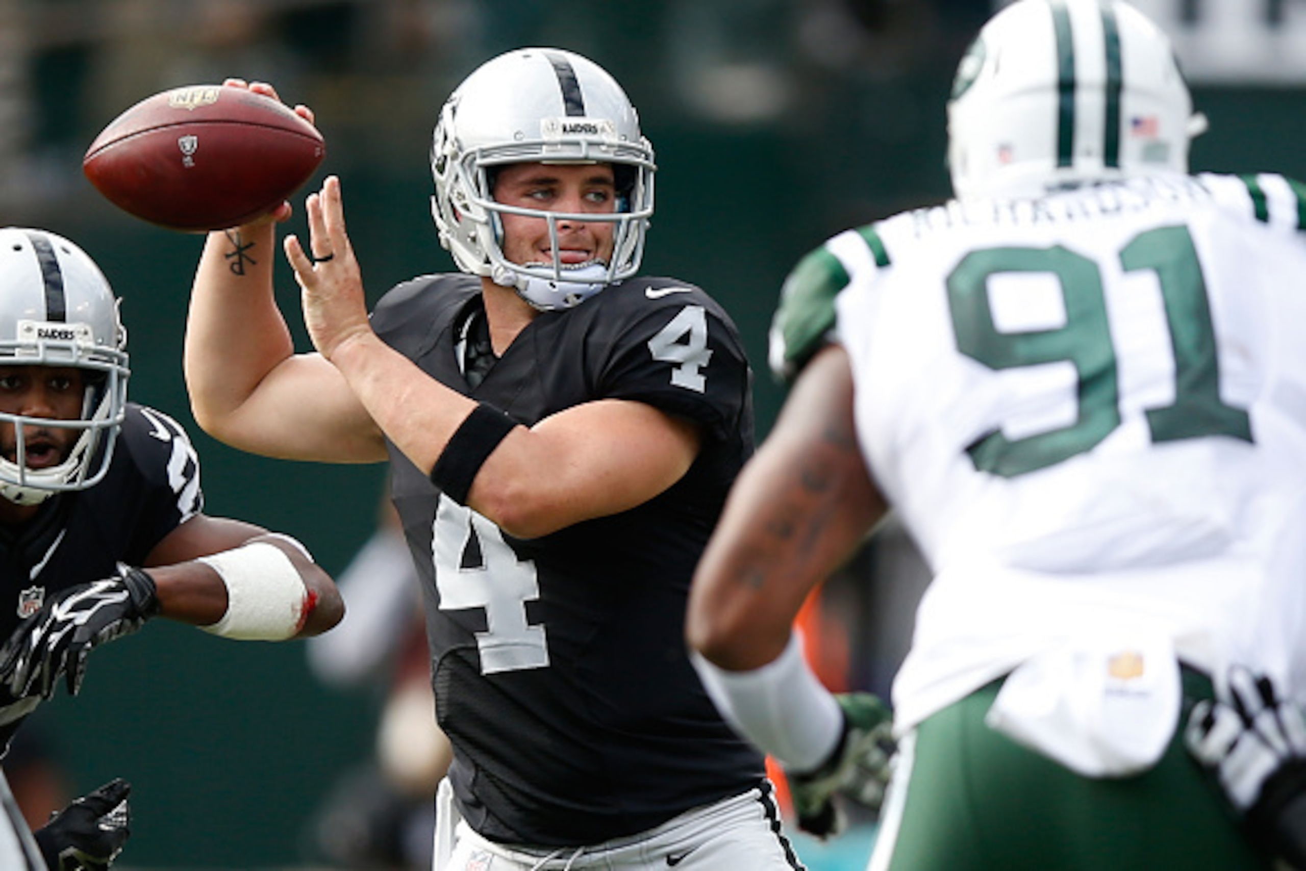 OAKLAND, CA - NOVEMBER 01:  Derek Carr #4 of the Oakland Raiders attempts a pass against the New York Jets during their NFL game at O.co Coliseum on November 1, 2015 in Oakland, California.  (Photo by Ezra Shaw/Getty Images)