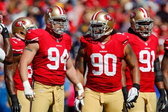 SAN FRANCISCO, CA - OCTOBER 7:  Defensive tackle Justin Smith #94, nose tackle Isaac Sopoaga #90, and defensive tackle Ray McDonald #91 of the San Francisco 49ers approach the line of scrimmage against the Buffalo Bills on October 7, 2012 at Candlestick P