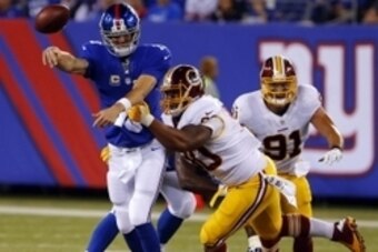 Sep 24, 2015; East Rutherford, NJ, USA; New York Giants quarterback Eli Manning (10) throw the ball away before being sacked by Washington Redskins defensive end Stephen Paea (90) during first half at MetLife Stadium. Mandatory Credit: Noah K. Murray-USA 