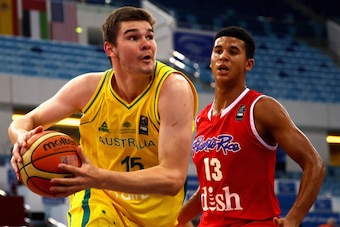 DUBAI, UNITED ARAB EMIRATES - AUGUST 14:  Isaac Humphries of Australia drives against Nick Berry of Puerto Rico during the FIBA U17 World Championships Quarter-Final match between  Australia and Puerto Rico at the Hamdan Sports Complex    on August 14, 20