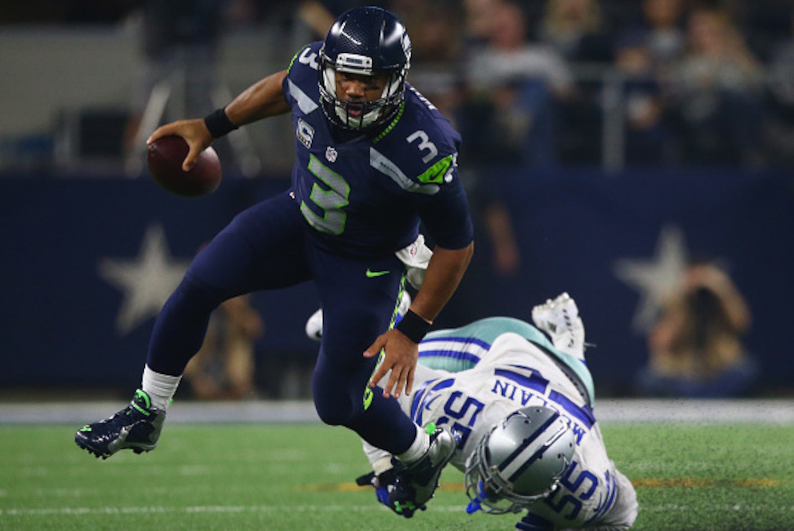 ARLINGTON, TX - NOVEMBER 01:  Russell Wilson #3 of the Seattle Seahawks runs the ball past  Rolando McClain #55 of the Dallas Cowboys in the second half at AT&T Stadium on November 1, 2015 in Arlington, Texas.  (Photo by Ronald Martinez/Getty Images)