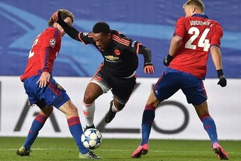 CSKA Moscow's Brazilian defender Mario Fernandes (L) and CSKA Moscow's Russian defender Vasily Berezutskiy (R) vie for the ball with Manchester United's French forward Anthony Martial during the UEFA Champions League group B football match between PFC CSK