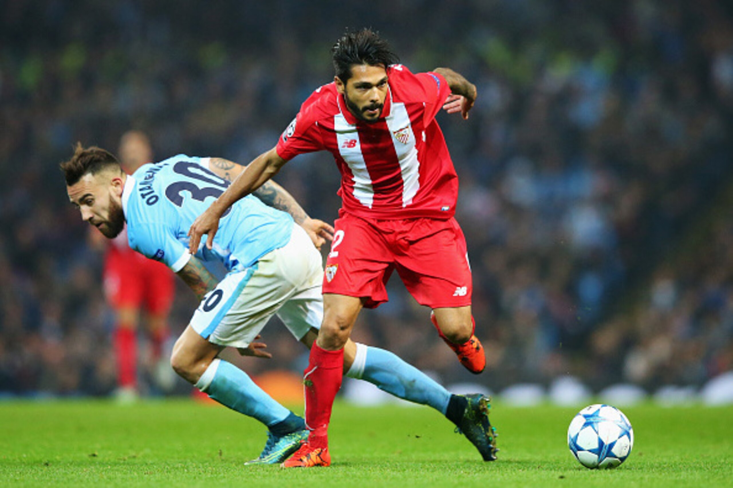 MANCHESTER, ENGLAND - OCTOBER 21:  Benoit Tremoulinas of Sevilla skips a challenge by Nicolas Otamendi of Manchester City during the UEFA Champions League Group D match between Manchester City and Sevilla at Etihad Stadium on October 21, 2015 in Mancheste
