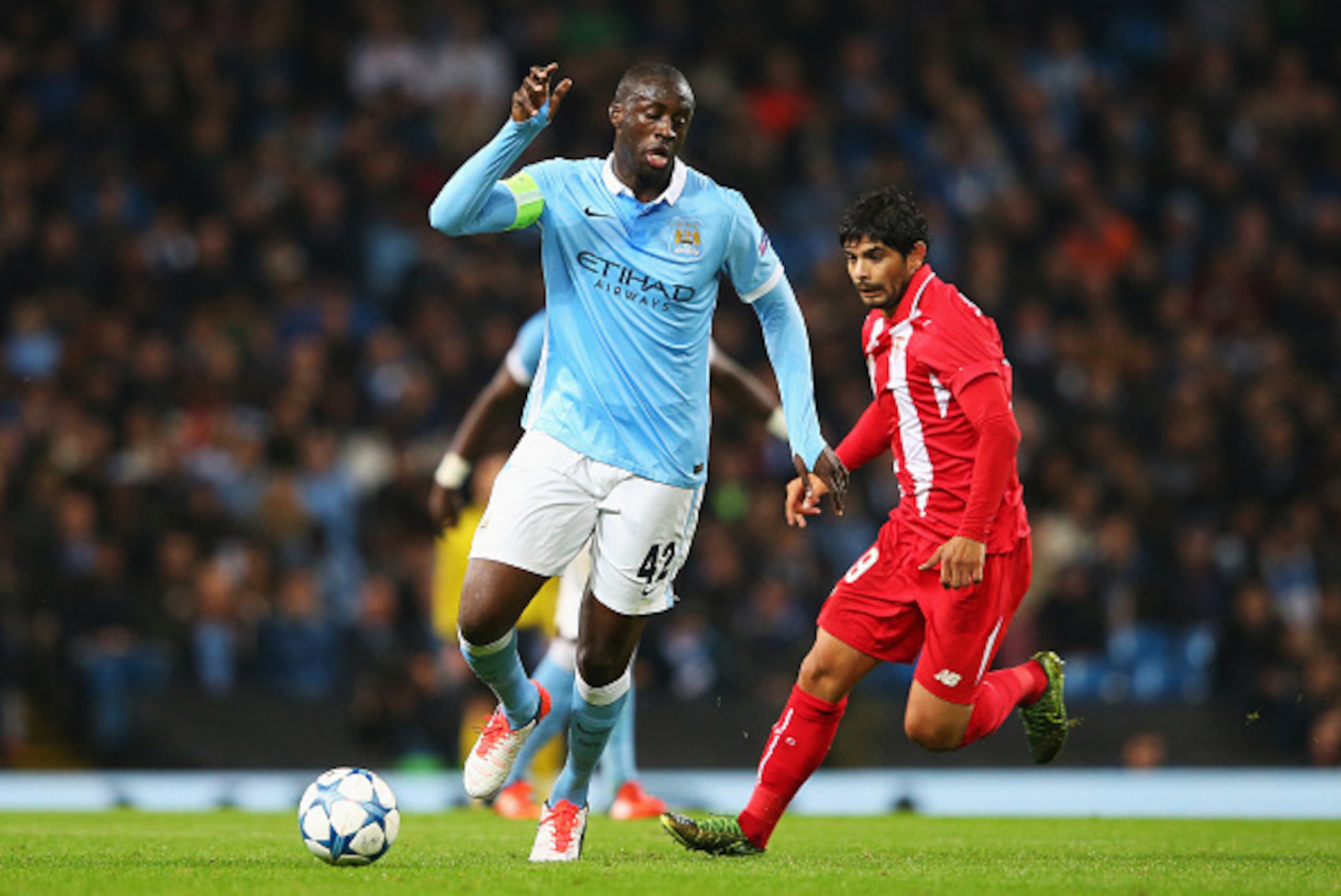 MANCHESTER, ENGLAND - OCTOBER 21:  Yaya Toure of Manchester City is closed down by Ever Banega of Sevilla during the UEFA Champions League Group D match between Manchester City and Sevilla at Etihad Stadium on October 21, 2015 in Manchester, United Kingdo