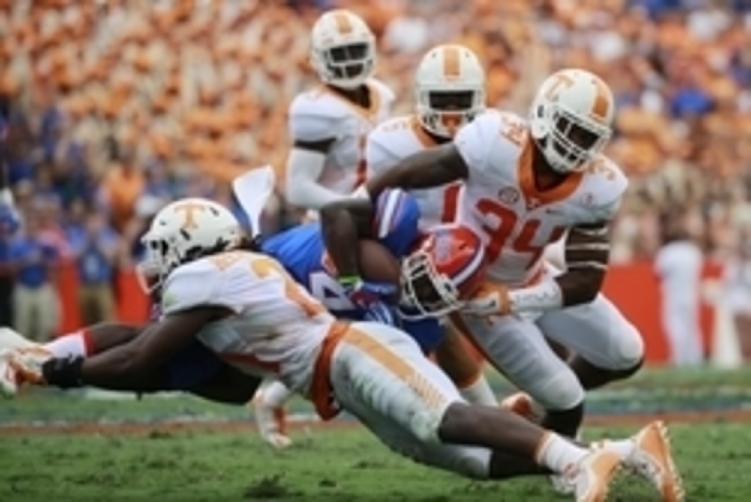Sep 26, 2015; Gainesville, FL, USA;  Florida Gators wide receiver Brandon Powell (4) runs with the ball as Tennessee Volunteers linebacker Jalen Reeves-Maybin (21) and linebacker Darrin Kirkland Jr. (34) defend during the first half at Ben Hill Griffin St