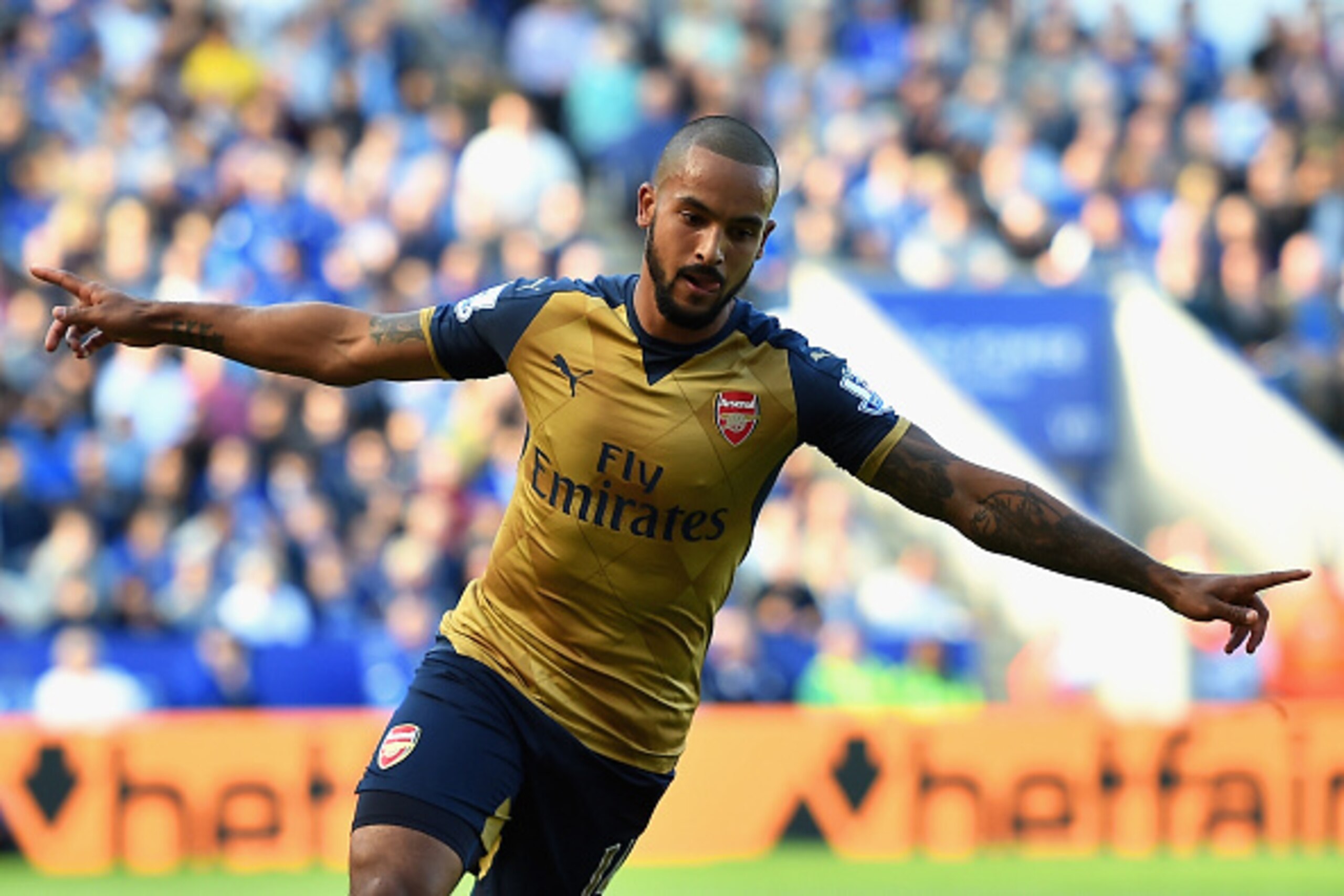 LEICESTER, ENGLAND - SEPTEMBER 26: Theo Walcott of Arsenal celebrates scoring his team's first goal during the Barclays Premier League match between Leicester City and Arsenal at The King Power Stadium on September 26, 2015 in Leicester, United Kingdom. LEICESTER, ENGLAND - SEPTEMBER 26: Theo Walcott of Arsenal celebrates scoring his team's first goal during the Barclays Premier League match between Leicester City and Arsenal at The King Power Stadium on September 26, 2015 in Leicester, United Kingdom.