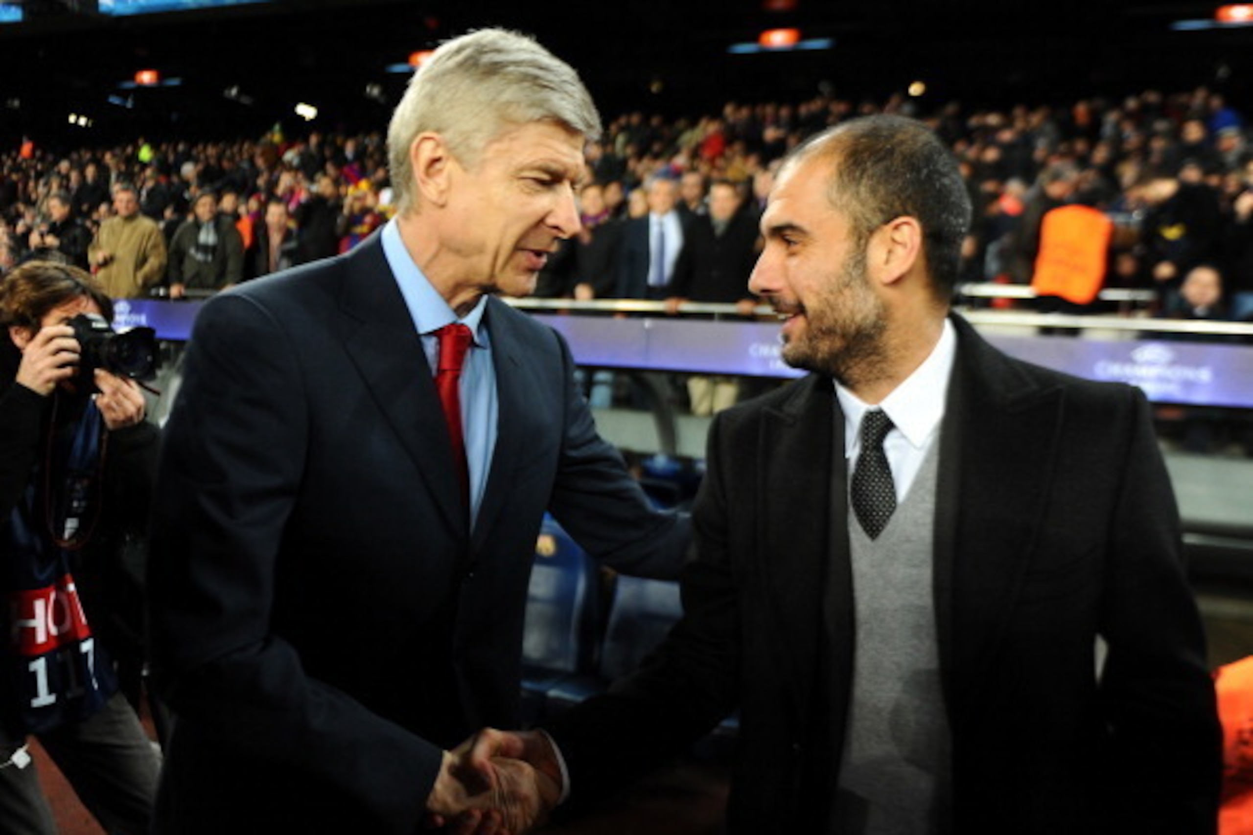 Barcelona's coach Pep Guardiola (R) welcomes Arsenal's French coach Arsène Wenger (L) before the Champions League round of 16 second leg football match FC Barcelona vs Arsenal CF on March 8, 2011 at Camp Nou stadium in Barcelona. AFP PHOTO / LLUIS GENE (P