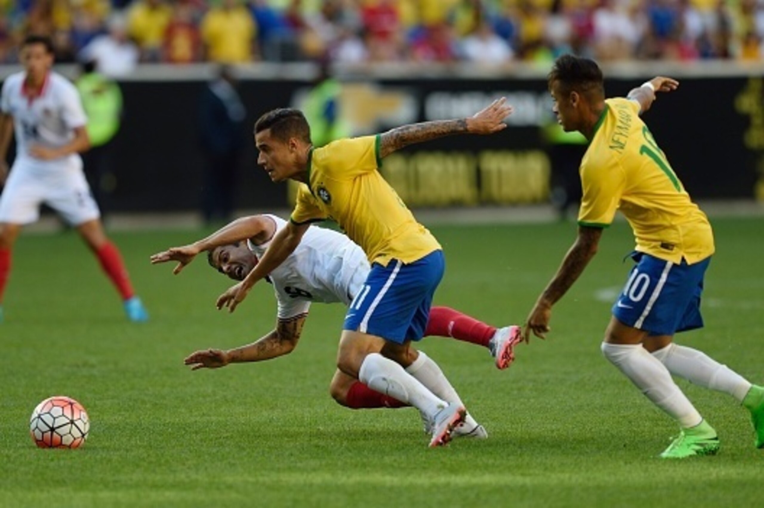 Brazil's Philippe Coutinho (11) makes his way toward the goal past Costa Rica's Christian Gamboa and in front of Brazil's Neymar (10) during the friendly match between Brazil and Costa Rica on September 5, 2015 at Red Bulls Arena in Harrison, New Jersey. 
