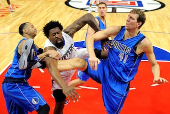 LOS ANGELES CA - OCTOBER 29: DeAndre Jordan #6 of the Los Angeles Clippers is fouled by Dirk Nowitzki #41 and Devin Harris of the Dallas Mavericks during the second quarter of the basketball game Staples Center October 29, 2015, in Los Angeles California.