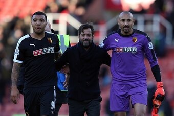 STOKE ON TRENT, ENGLAND - OCTOBER 24: Watford manager Quique Sanchez Flores (C) celebrates at full-time with Troy Deeney (L) and Heurelho Gomes following the Barclays Premier League match between Stoke City and Watford on October 24, 2015 in Stoke on Tren