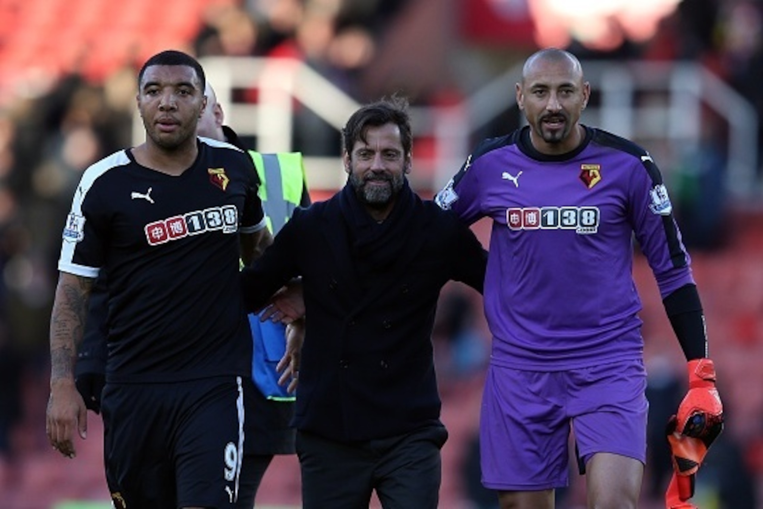 STOKE ON TRENT, ENGLAND - OCTOBER 24: Watford manager Quique Sanchez Flores (C) celebrates at full-time with Troy Deeney (L) and Heurelho Gomes following the Barclays Premier League match between Stoke City and Watford on October 24, 2015 in Stoke on Tren