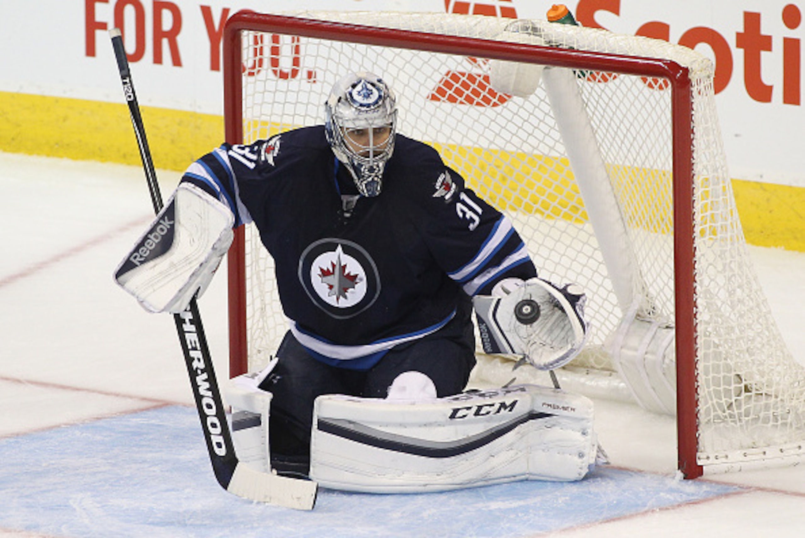 WINNIPEG, MB - OCTOBER 16: Ondrej Pavelec #31 of the Winnipeg Jets grabs the puck during third period action in an NHL game against the Calgary Flames at the MTS Centre on October 16, 2015 in Winnipeg, Manitoba, Canada. (Photo by Marianne Helm/Getty Image