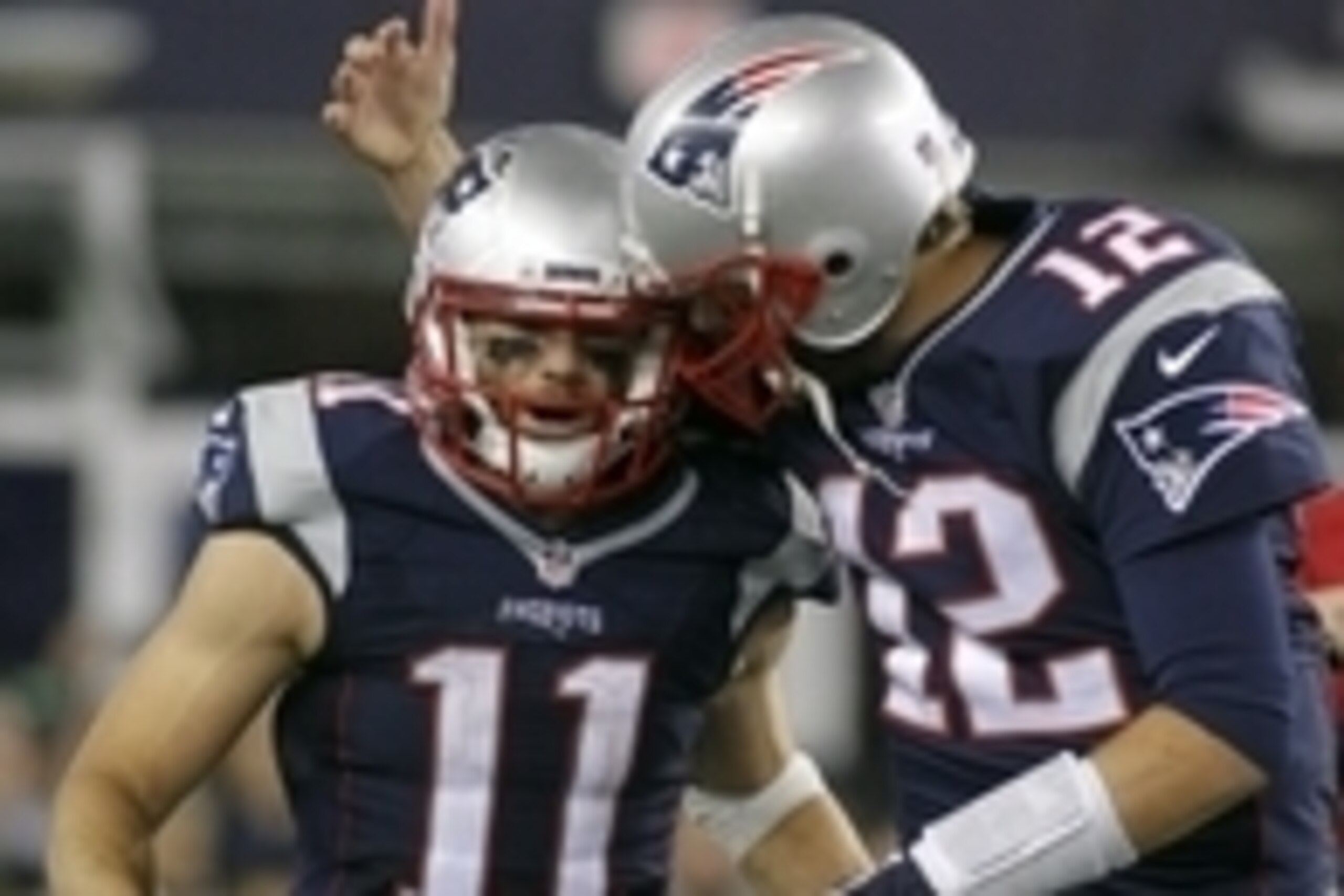 Oct 29, 2015; Foxborough, MA, USA; New England Patriots quarterback Tom Brady (12) celebrates a touchdown pass to wide receiver Julian Edelman (11)  during the fourth quarter against the Miami Dolphins at Gillette Stadium. Mandatory Credit: Stew Milne-USA