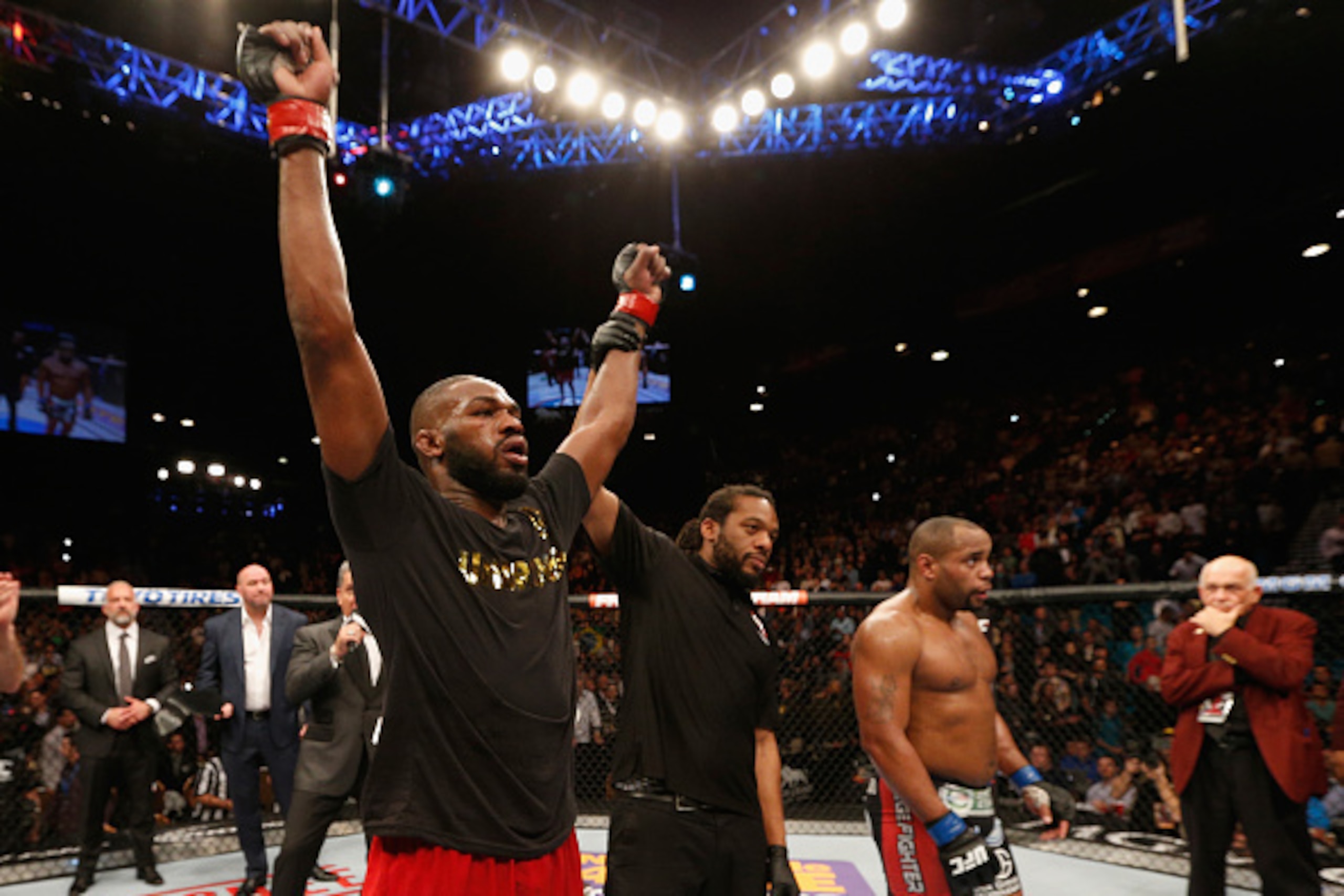 LAS VEGAS, NV - JANUARY 03:  UFC light heavyweight champion Jon Jones (L) celebrates his win over Daniel Cormier (R) in their UFC light heavyweight championship bout during the UFC 182 event at the MGM Grand Garden Arena on January 3, 2015 in Las Vegas, N