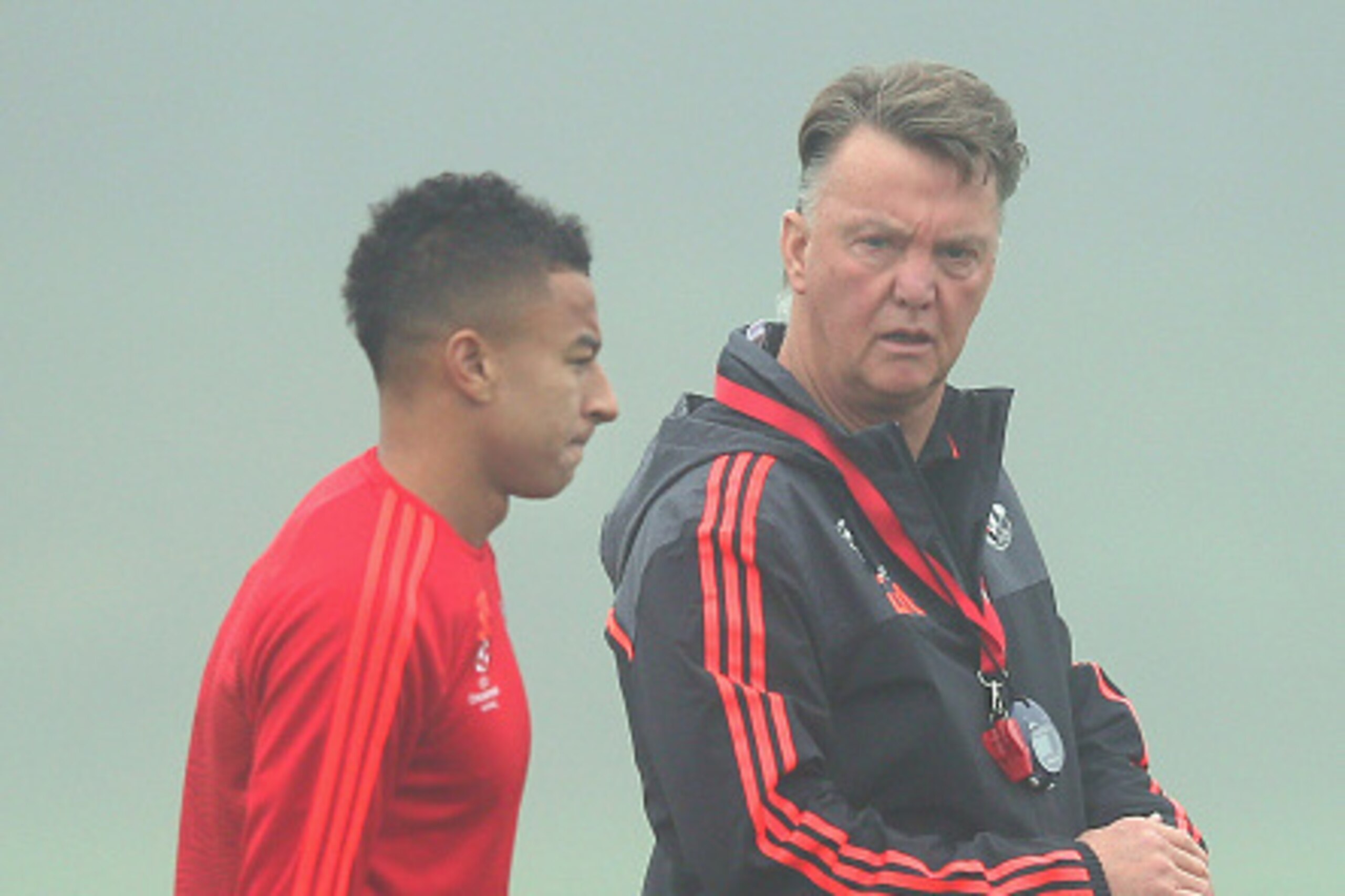 MANCHESTER, ENGLAND - NOVEMBER 02:  Louis van Gaal the manager of Manchester United talks with Jesse Lingard prior to a Manchester United training session on the eve of the UEFA Champions League Group B match against CSKA Moscow at Aon Training Complex on