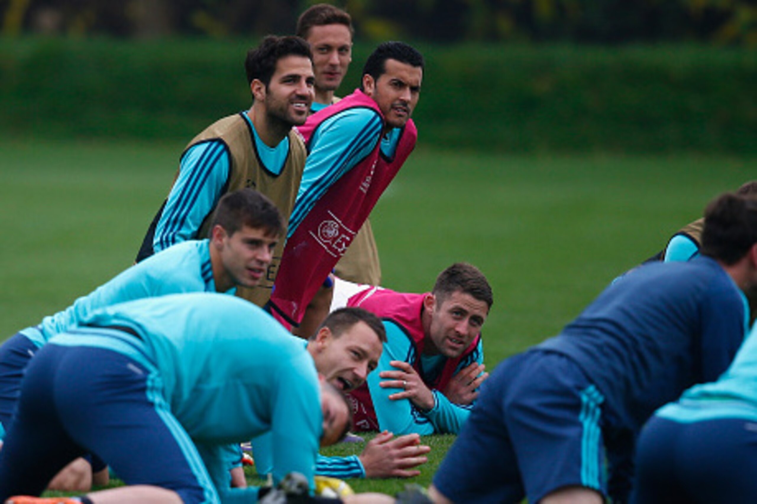 COBHAM, ENGLAND - NOVEMBER 03:  Cesc Fabregas and Pedro of Chelsea stretch during a Chelsea training session, ahead of the UEFA Champions League Group G match between Chelsea and Dynamo Kiev, at Chelsea Training Ground on November 3, 2015 in Cobham, Engla