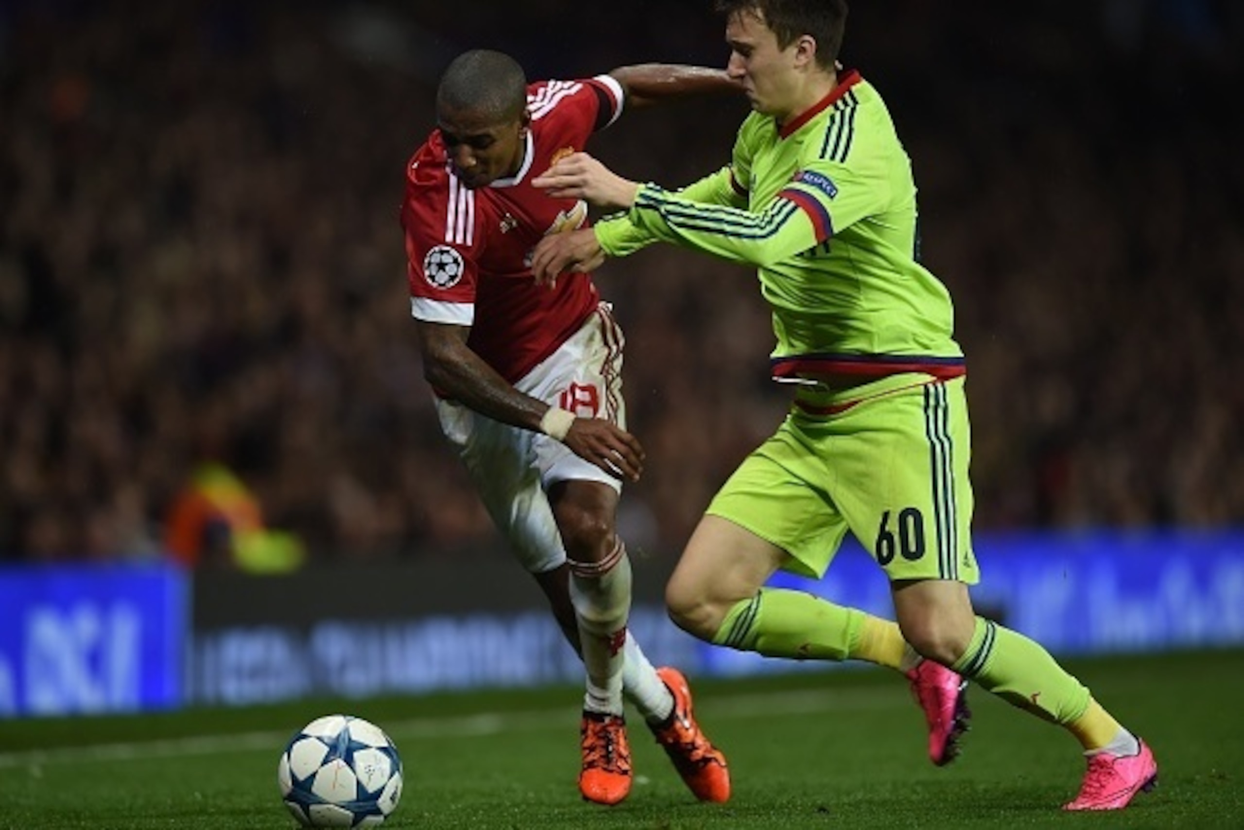 Manchester United's English midfielder Ashley Young (L) vies with CSKA Moscow's defender Aleksandr Golovin during a UEFA Chamions league group stage football match between CSKA Moscow and Manchester United at Old Trafford in Manchester, north west England