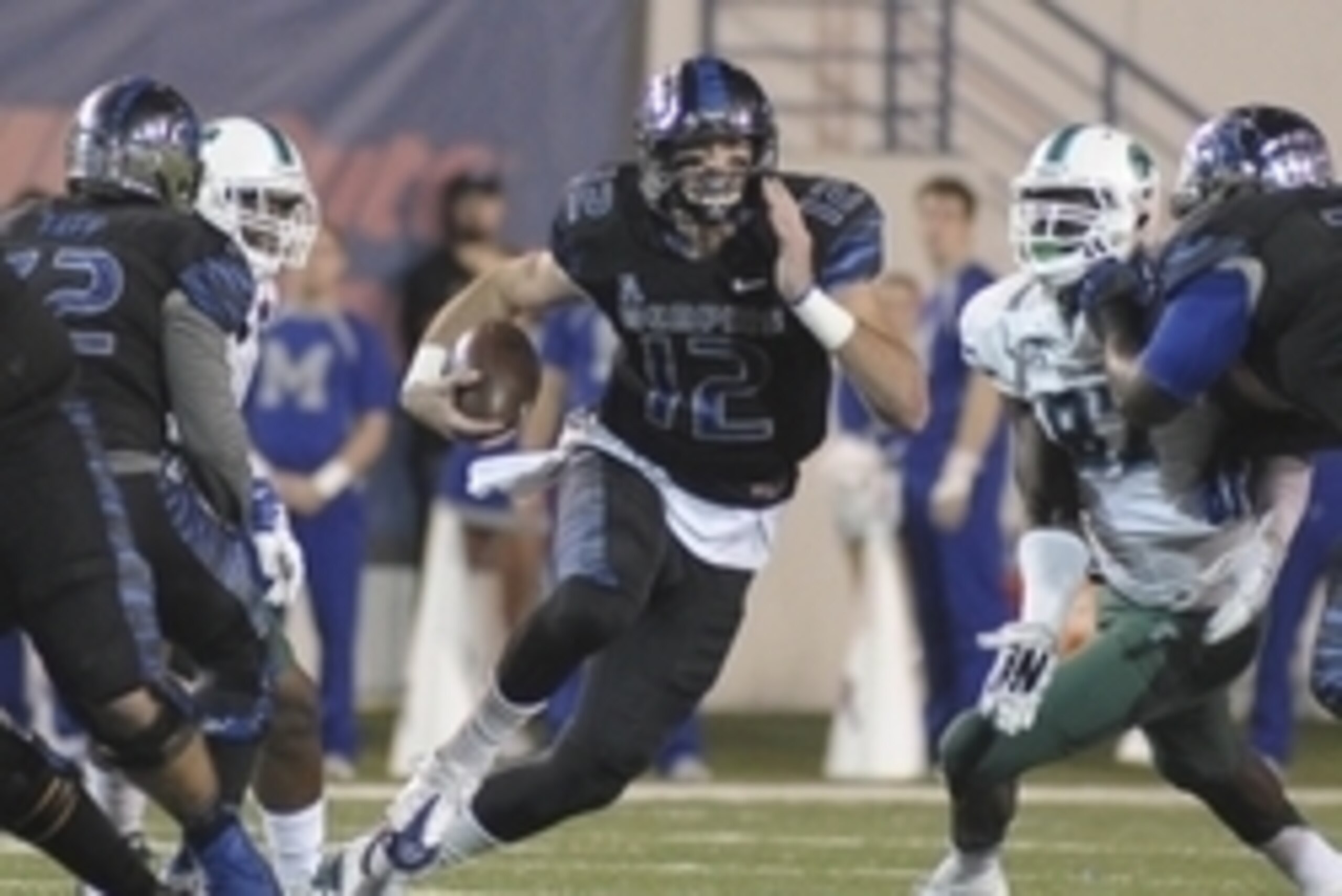 Oct 31, 2015; Memphis, TN, USA; Memphis Tigers quarterback Paxton Lynch (12) carries the ball against Tulane Green Wave defensive end Ade Aruna (87) during the second half at Liberty Bowl Memorial Stadium. Memphis Tigers beat Tulane Green Wave 41 - 13. Ma