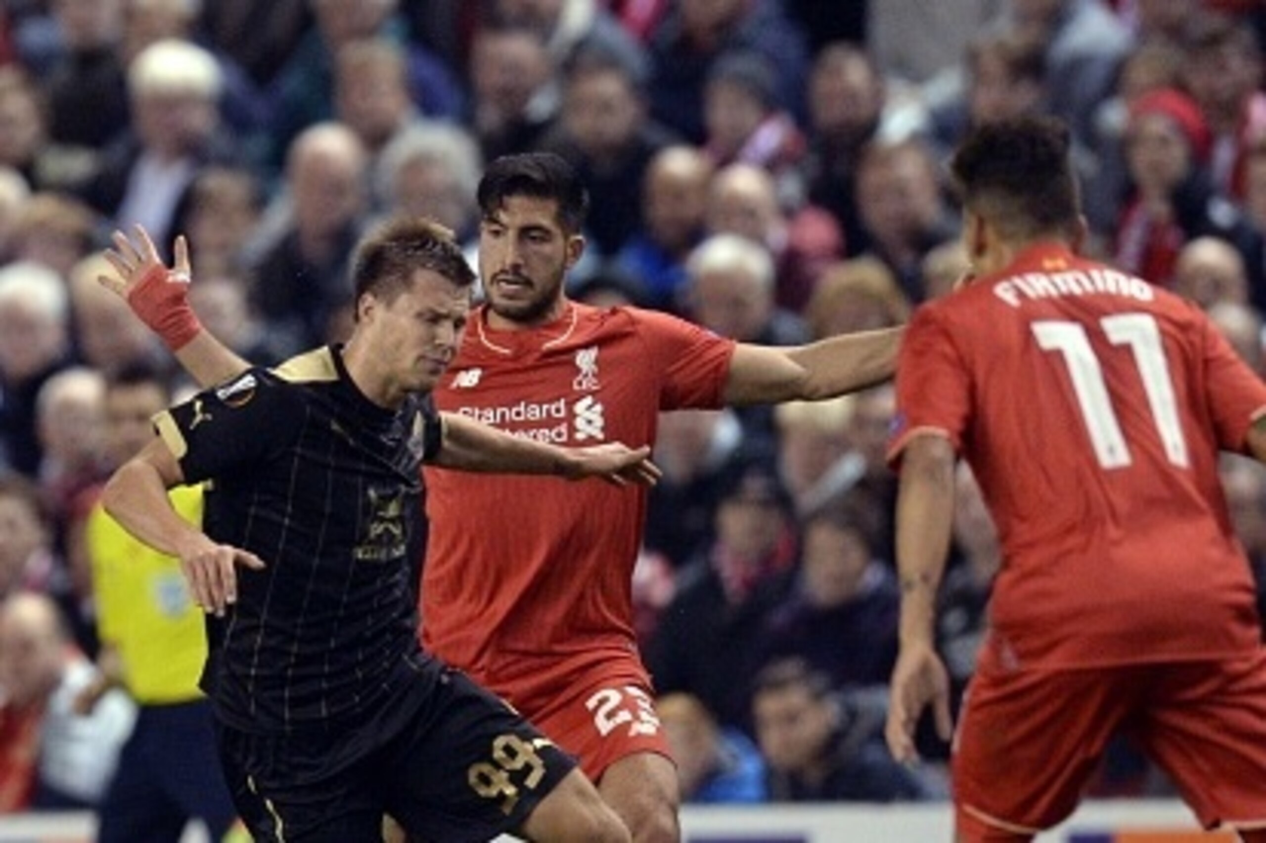 Liverpool's German midfielder Emre Can (C) fouls Rubin Kazan's Russian striker Maksim Kanunnikov (L)  during a UEFA Europa League group B football match between Liverpool FC and FC Rubin Kazan at Anfield in Liverpool, north west England, on October 22, 20
