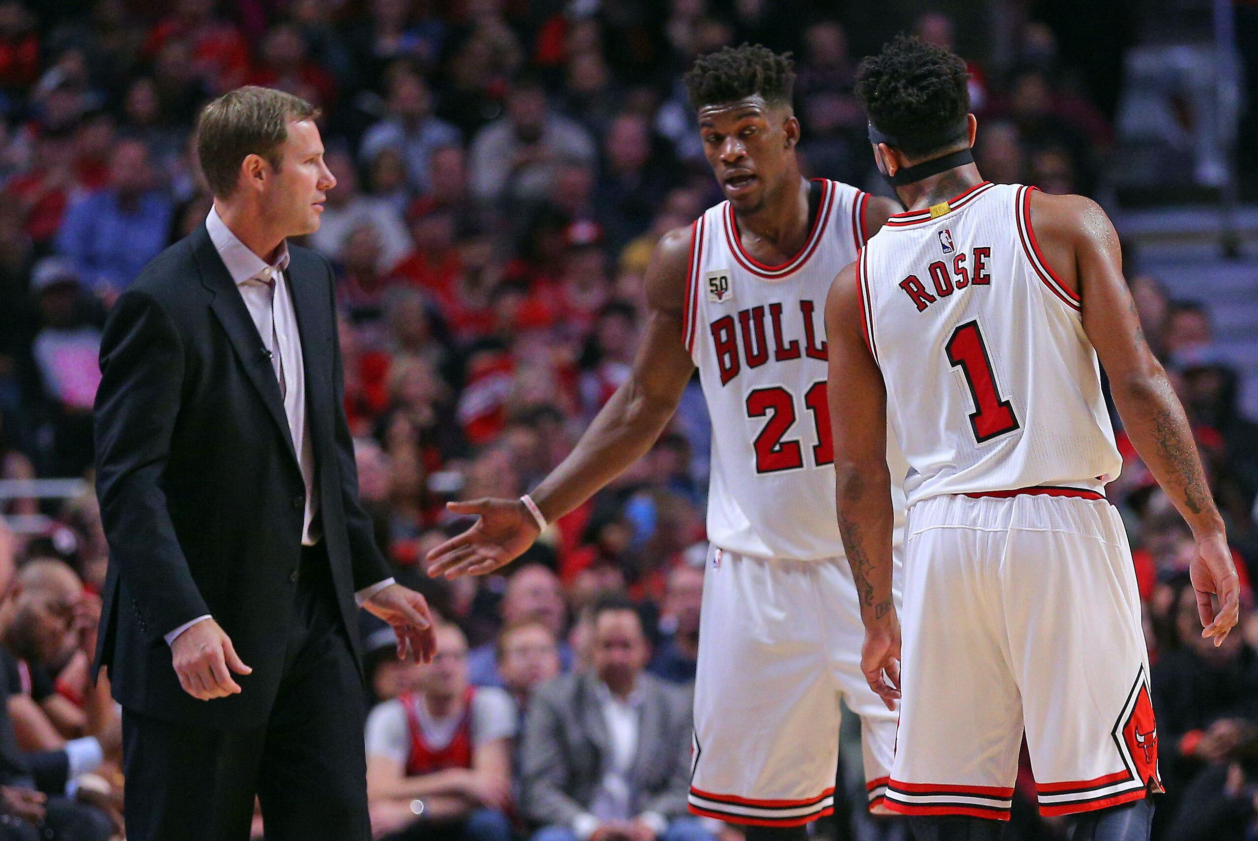 Oct 27, 2015; Chicago, IL, USA; Chicago Bulls head coach Fred Hoiberg talks with guard Jimmy Butler (21) and guard Derrick Rose (1) during the second half against the Cleveland Cavaliers at the United Center. Chicago won 97-95. Mandatory Credit: Dennis Wi