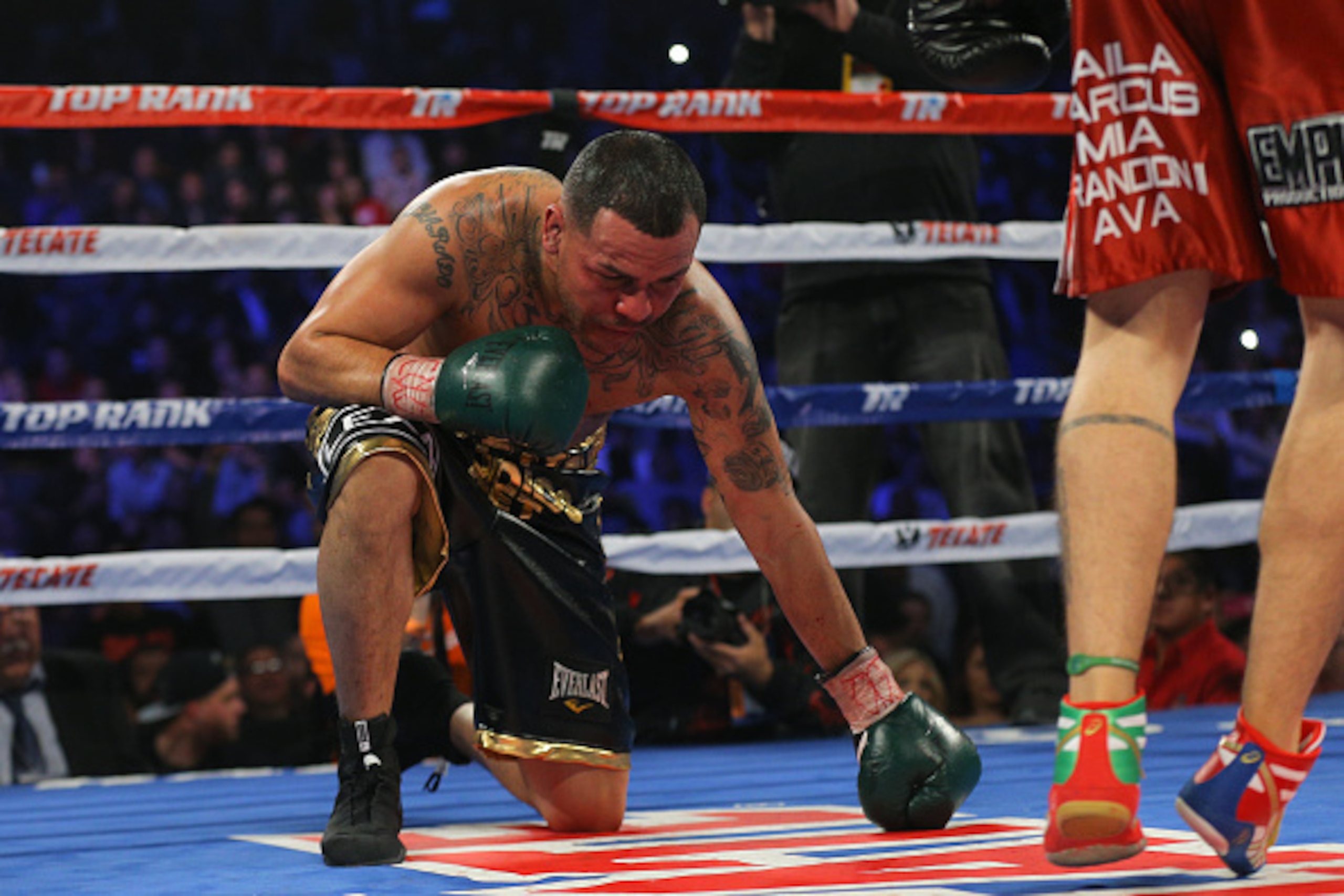 BROOMFIELD, CO - JANUARY 24:  Mike Alvarado (L) falls to his knees against Brandon Rios during a WBO International Welterweight Title fight at First Bank Center on January 24, 2015 in Broomfield, Colorado. Rios won by TKO at the start of the fourth round.