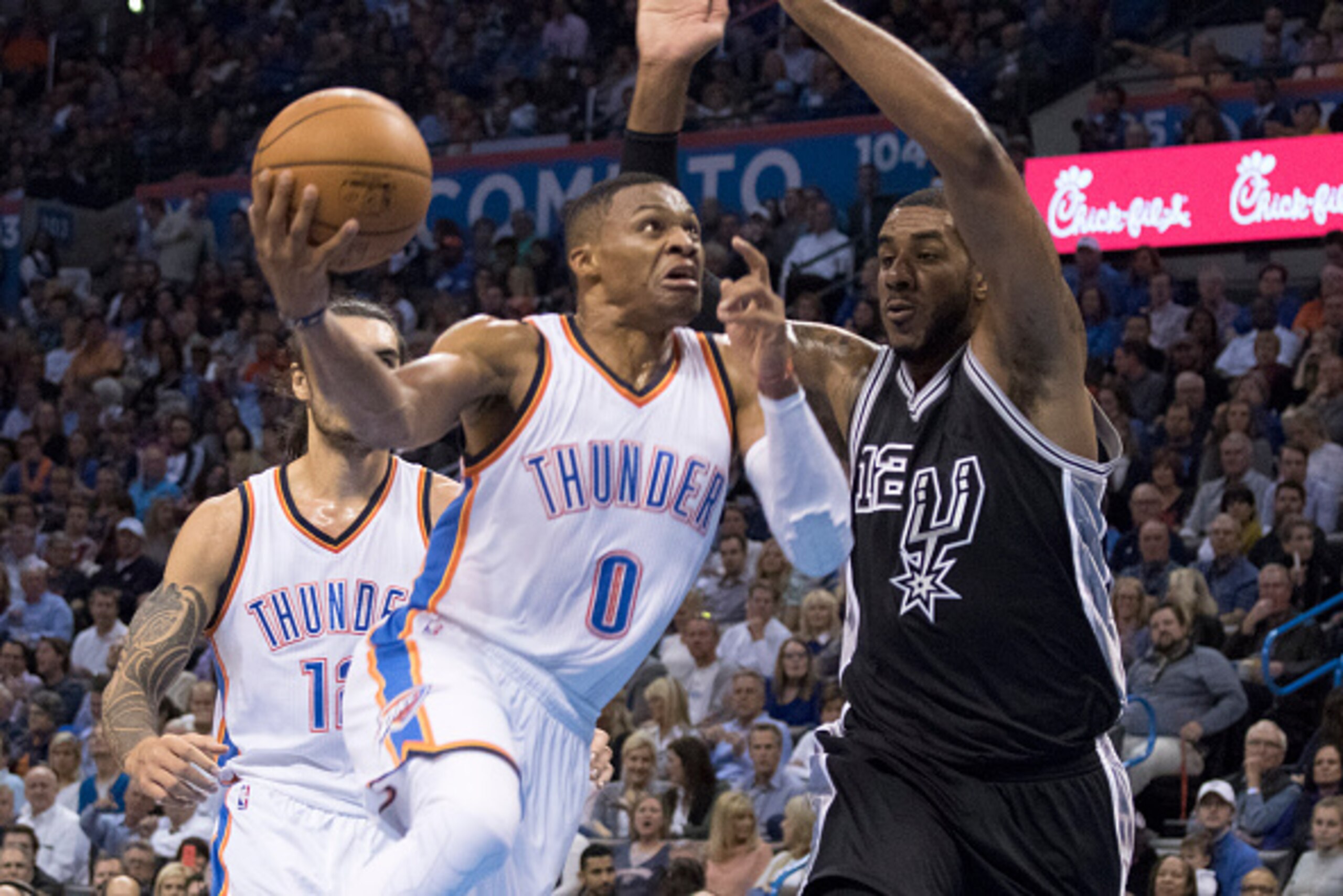 OKLAHOMA CITY, OK - OCTOBER 28: LaMarcus Aldridge #12 of the San Antonio Spurs fails to block Russell Westbrook #0 of the Oklahoma City Thunder during the first quarter of a NBA game at the Chesapeake Energy Center on October 28, 2015 in Oklahoma City, Ok