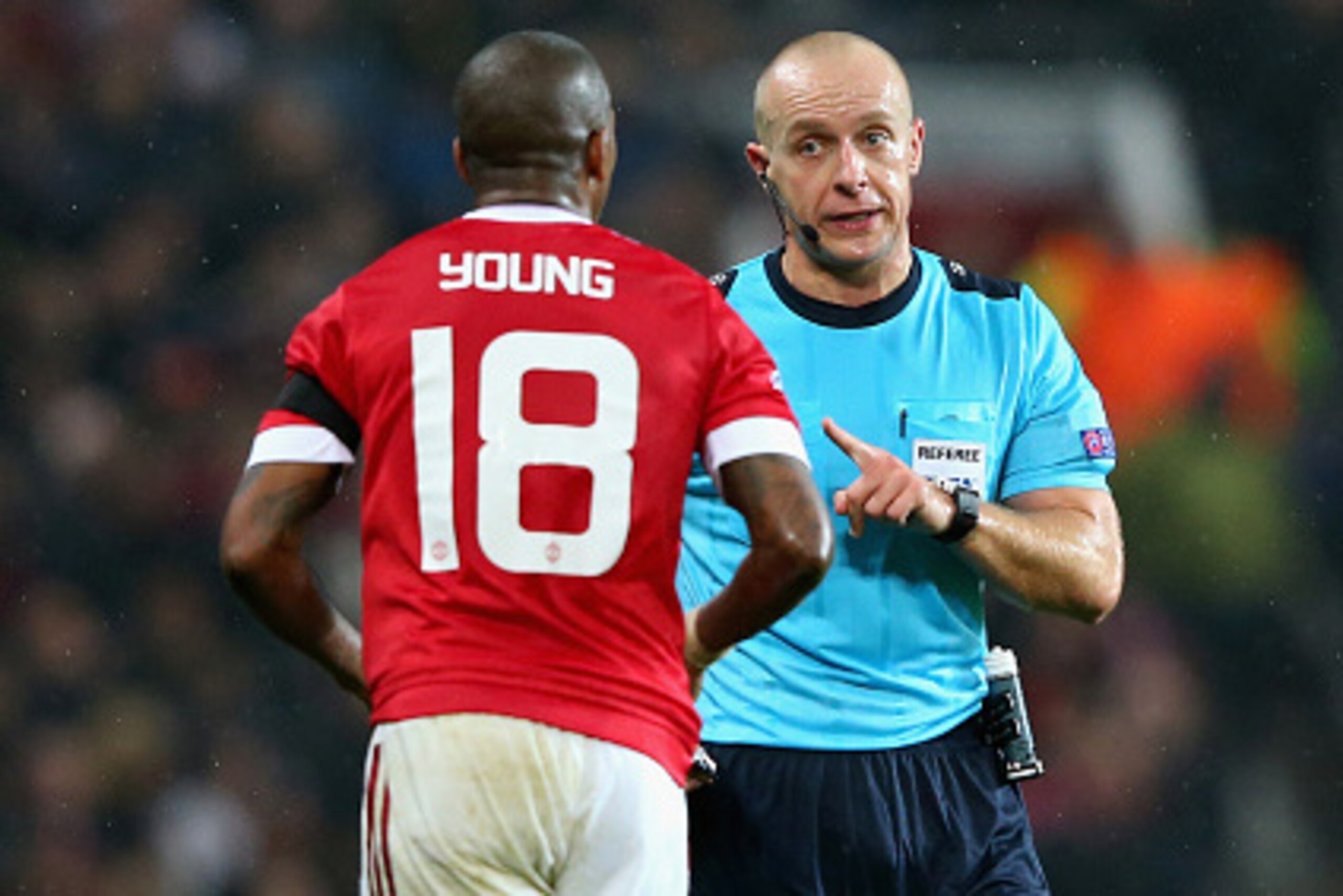 MANCHESTER, ENGLAND - NOVEMBER 03:  Referee Szymon Marciniak talks to Ashley Young of Manchester United during the UEFA Champions League Group B match between Manchester United FC and PFC CSKA Moskva at Old Trafford on November 3, 2015 in Manchester, Unit