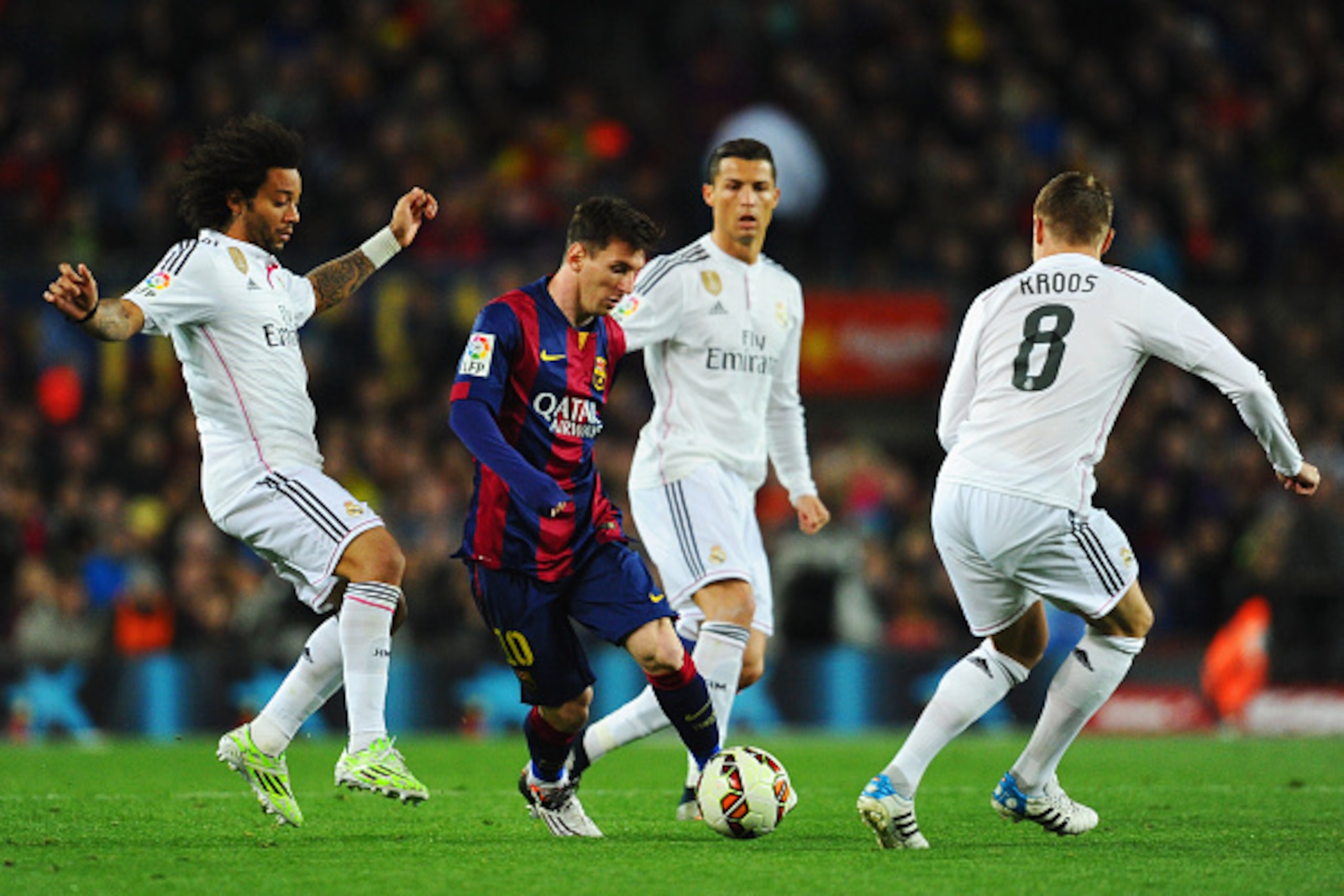 BARCELONA, SPAIN - MARCH 22:  Lionel Messi of Barcelona takes on Marcelo (L), Cristiano Ronaldo (2R) and Toni Kroos of Real Madrid CF (R) during the La Liga match between FC Barcelona and Real Madrid CF at Camp Nou on March 22, 2015 in Barcelona, Spain.  
