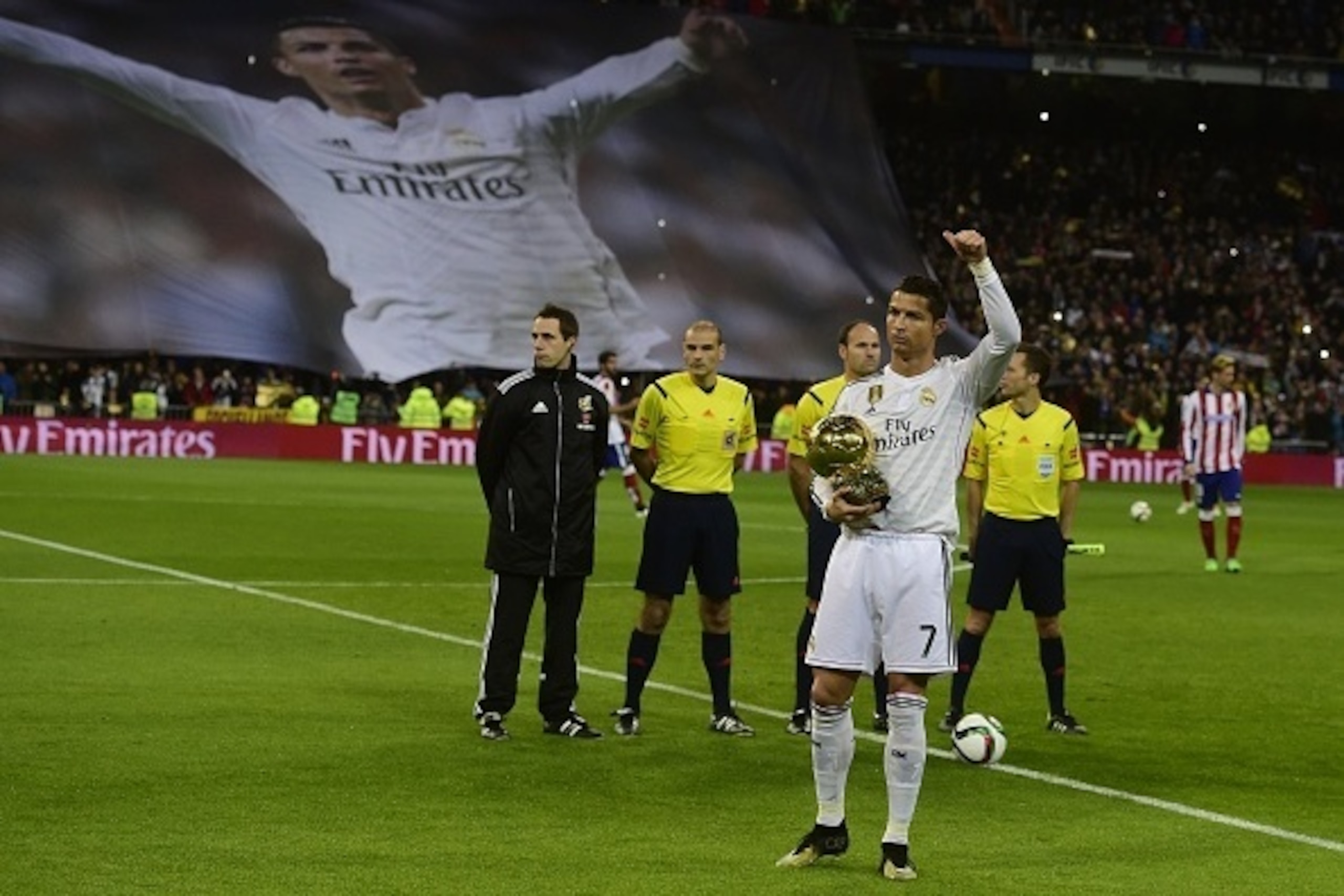Real Madrid's Portuguese forward Cristiano Ronaldo poses with the 2014 FIFA Ballon d'Or award for player of the year prior to the Spanish Copa del Rey (King's Cup) round of 16 second leg football match Real Madrid CF vs Club Atletico de Madrid at the Sant Real Madrid's Portuguese forward Cristiano Ronaldo poses with the 2014 FIFA Ballon d'Or award for player of the year prior to the Spanish Copa del Rey (King's Cup) round of 16 second leg football match Real Madrid CF vs Club Atletico de Madrid at the Sant