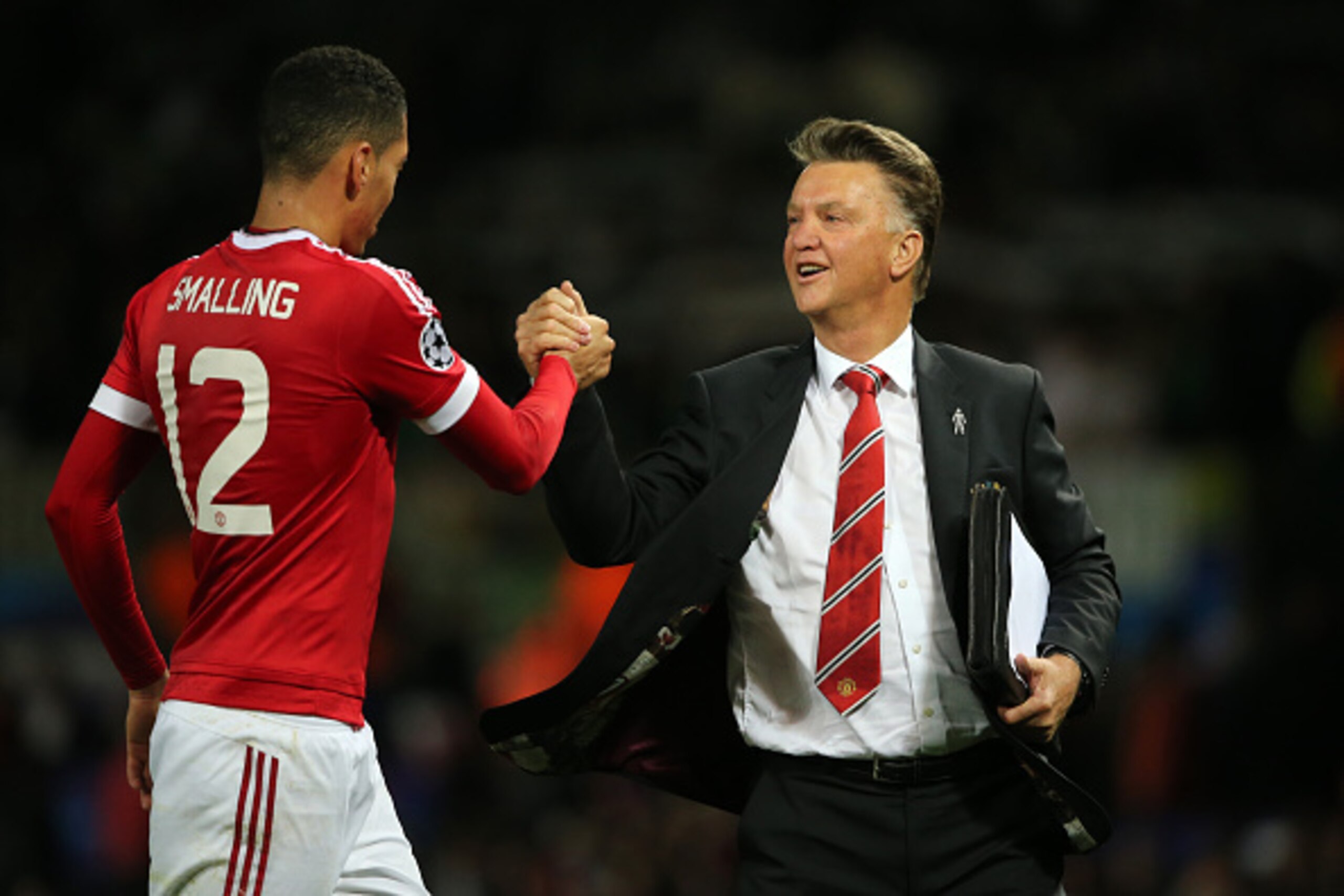 MANCHESTER, ENGLAND - SEPTEMBER 30:  Chris Smalling of Manchester United who scored the winning goal gets congratulated by Louis van Gaal the head coach / manager of Manchester United at the end of the UEFA Champions League match between Manchester United