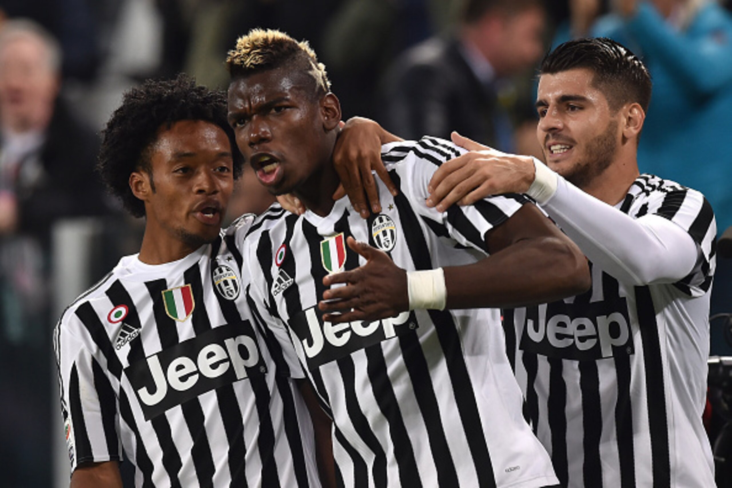 TURIN, ITALY - OCTOBER 31:  Paul Pogba (C) of Juventus FC celebrates after scoring the opening goal with team  mates Juan Cuadrado (L) and Alvaro Morata during the Serie A match between Juventus FC and Torino FC at Juventus Arena on October 31, 2015 in Tu