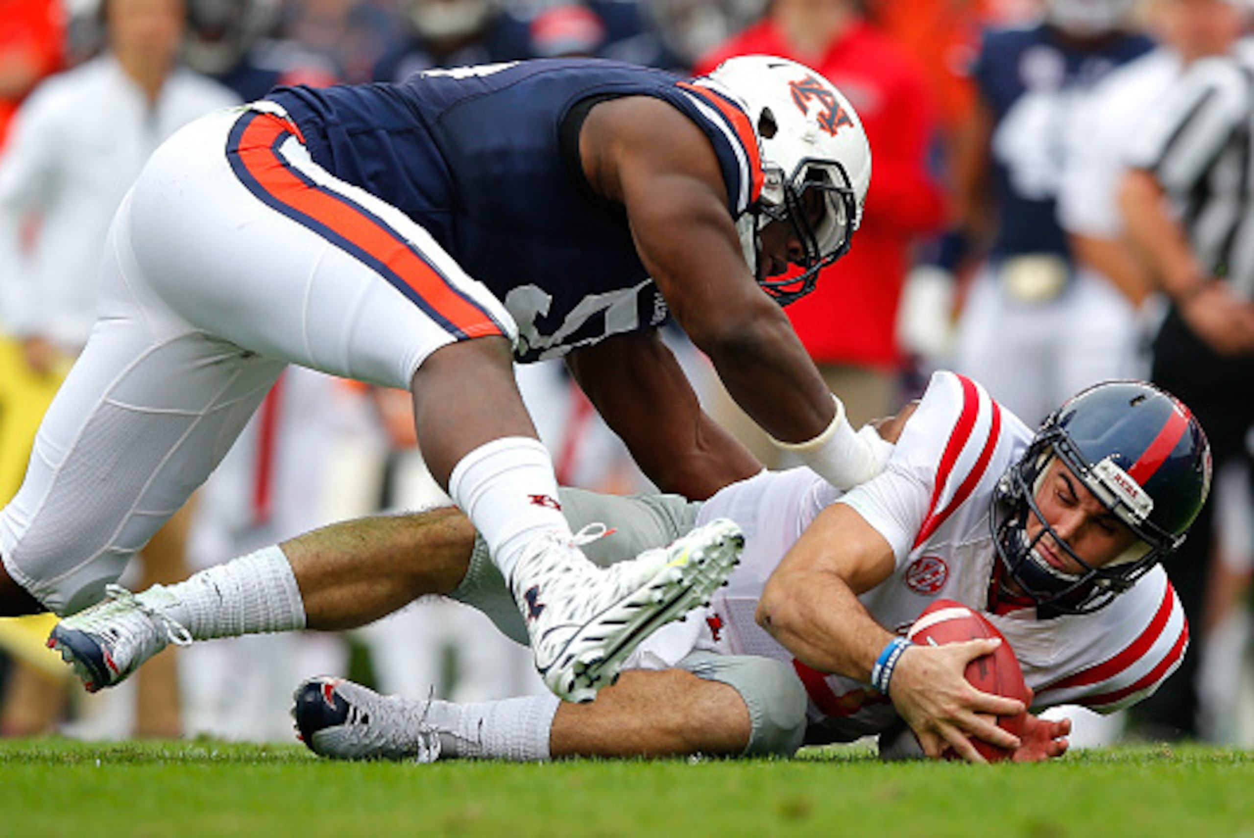AUBURN, AL - OCTOBER 31:  Chad Kelly #10 of the Mississippi Rebels jumps on his fumble as he is tackled by Carl Lawson #55 of the Auburn Tigers at Jordan-Hare Stadium on October 31, 2015 in Auburn, Alabama.  (Photo by Kevin C. Cox/Getty Images)