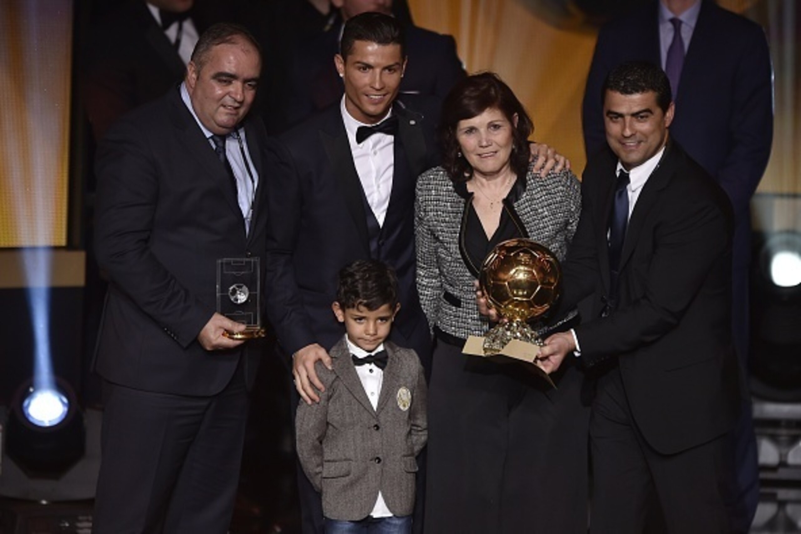 Real Madrid and Portugal forward Cristiano Ronaldo (C) poses with his son Cristiano Jr (2nd L), mother Dolores (2nd R), brother Hugo (R) and an unidentified family member   after receiving the 2014 FIFA Ballon d'Or award for player of the year during the 