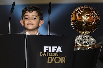 Cristiano Jr, son of Real Madrid and Portugal forward Cristiano Ronaldo, looks over the speech podium on stage as his fathers receives the 2014 FIFA Ballon d'Or award for player of the year during the FIFA Ballon d'Or award ceremony at the Kongresshaus in