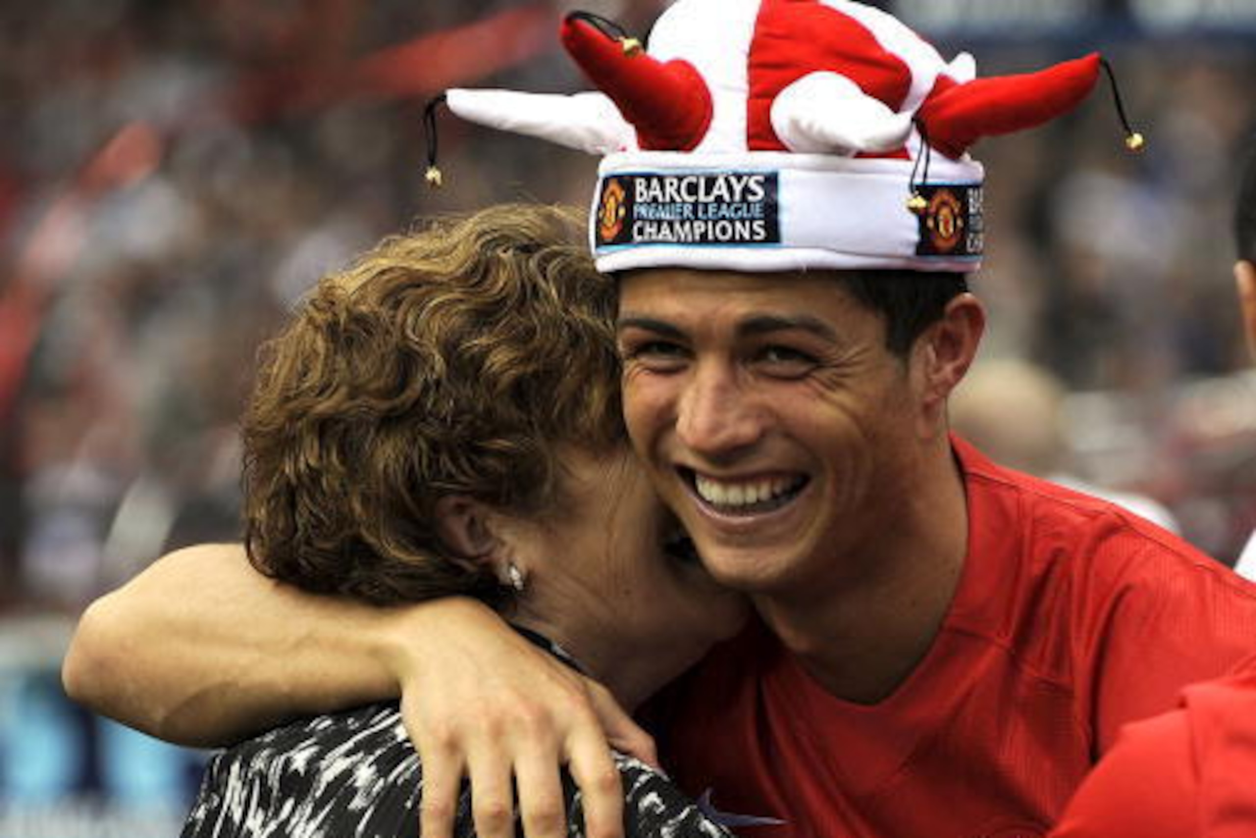 Manchester United's Portuguese midfielder Cristiano Ronaldo (R) gets a hug from his mother Delores Avero (L) after the 0-0 draw with Arsenal in the English Premier League football match at Old Trafford, Manchester, north-west England, on May 16, 2009.The 