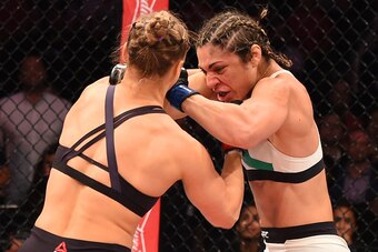 RIO DE JANEIRO, BRAZIL - AUGUST 01:  (L-R) Ronda Rousey of the United States punches Bethe Correia of Brazil in their UFC women's bantamweight championship bout during the UFC 190 event inside HSBC Arena on August 1, 2015 in Rio de Janeiro, Brazil.  (Phot