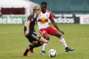 Nov 1, 2015; Washington, DC, USA; D.C. United forward Chris Rolfe (18) and New York Red Bulls defender Kemar Lawrence (92) battle for the ball in the first half of the first leg of the eastern conference semi-final at Robert F. Kennedy Memorial Stadium. M