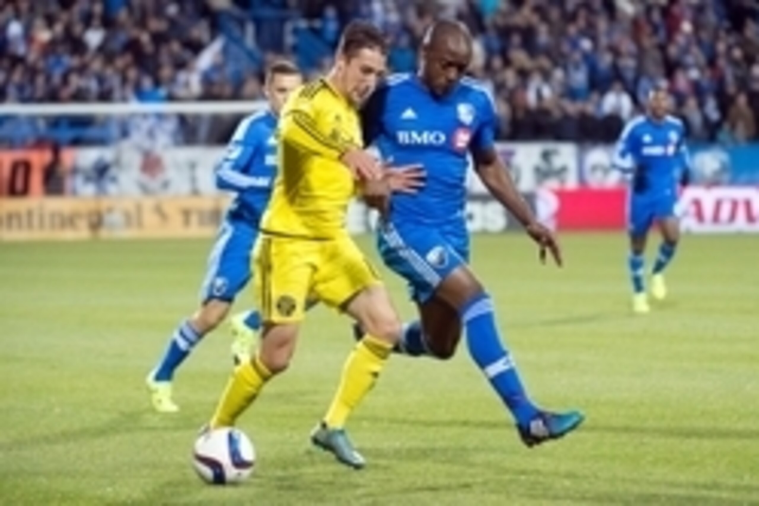 Nov 1, 2015; Montreal, Quebec, CAN; Columbus Crew midfielder Ethan Finlay (13) and Montreal Impact Nigel Reo-Coker (14) battle for control of the ball in the second half at Stade Saputo. The Impact defeated the Columbus Crew 2-1. Mandatory Credit: Marc De