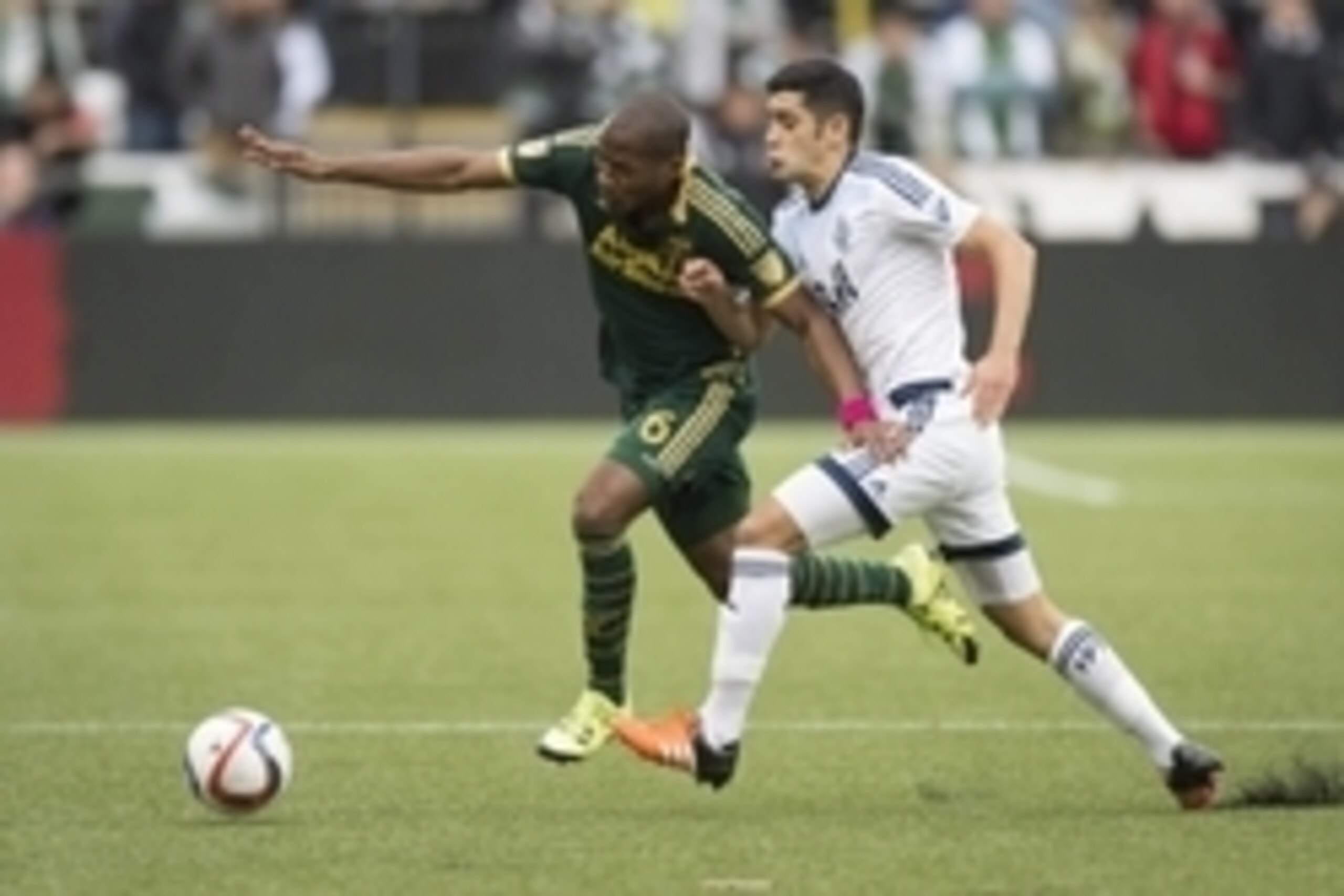 Nov 1, 2015; Portland, OR, USA; Portland Timbers midfielder Darlington Nagbe (6) runs after a ball as he is guarded by Vancouver Whitecaps midfielder Matias Laba (15) during the first half of an MLS playoff game at Providence Park. The game ended 0-0. Man