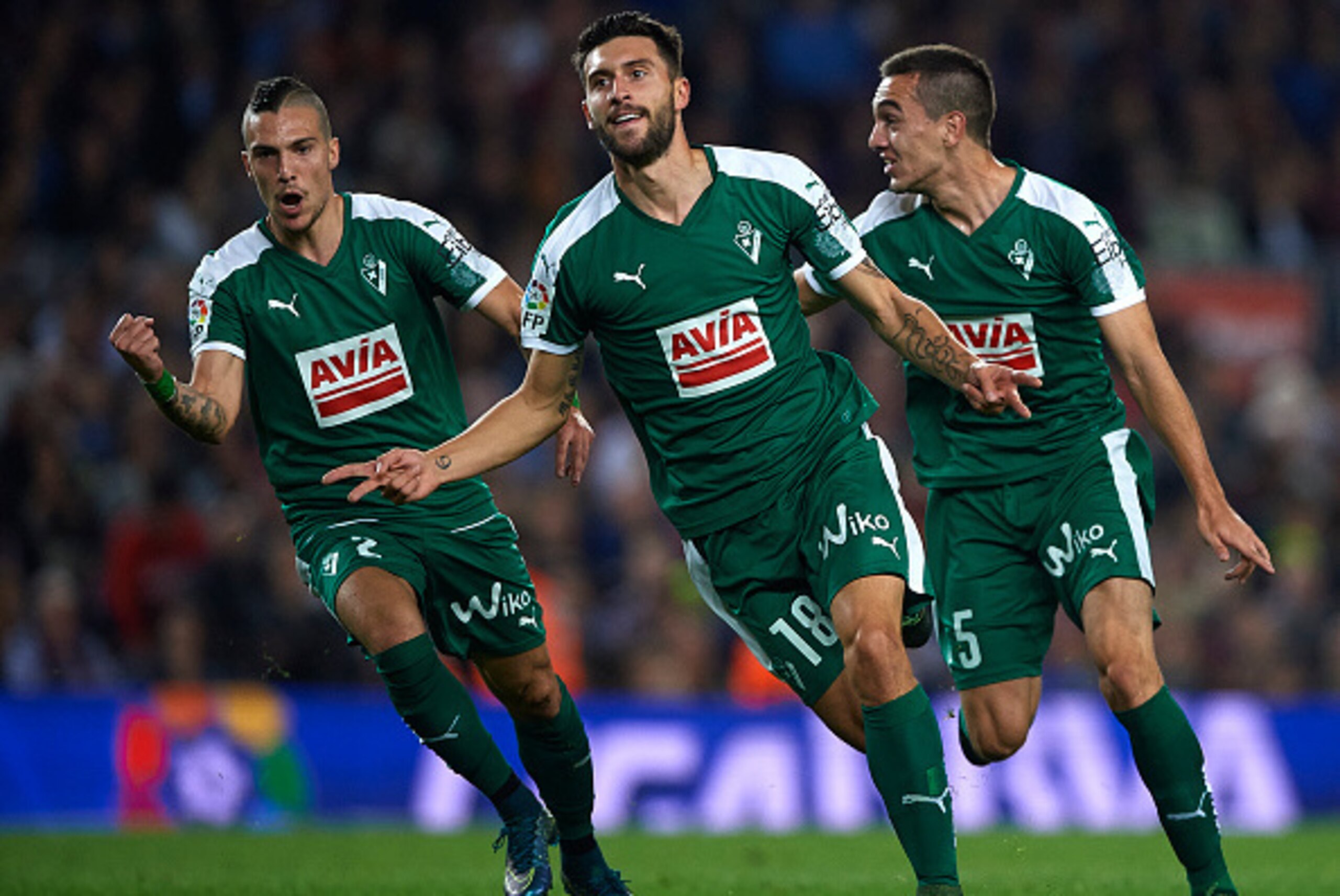 BARCELONA, SPAIN - OCTOBER 25:  Borja Gonzalez Tomas 'Baston' of Eibar celebrates scoring his team's first goal with Simone Verdi (L) and Gonzalo Escalante (R) during the La Liga match between FC Barcelona and SD Eibar at Camp Nou Stadium on October 25, 2