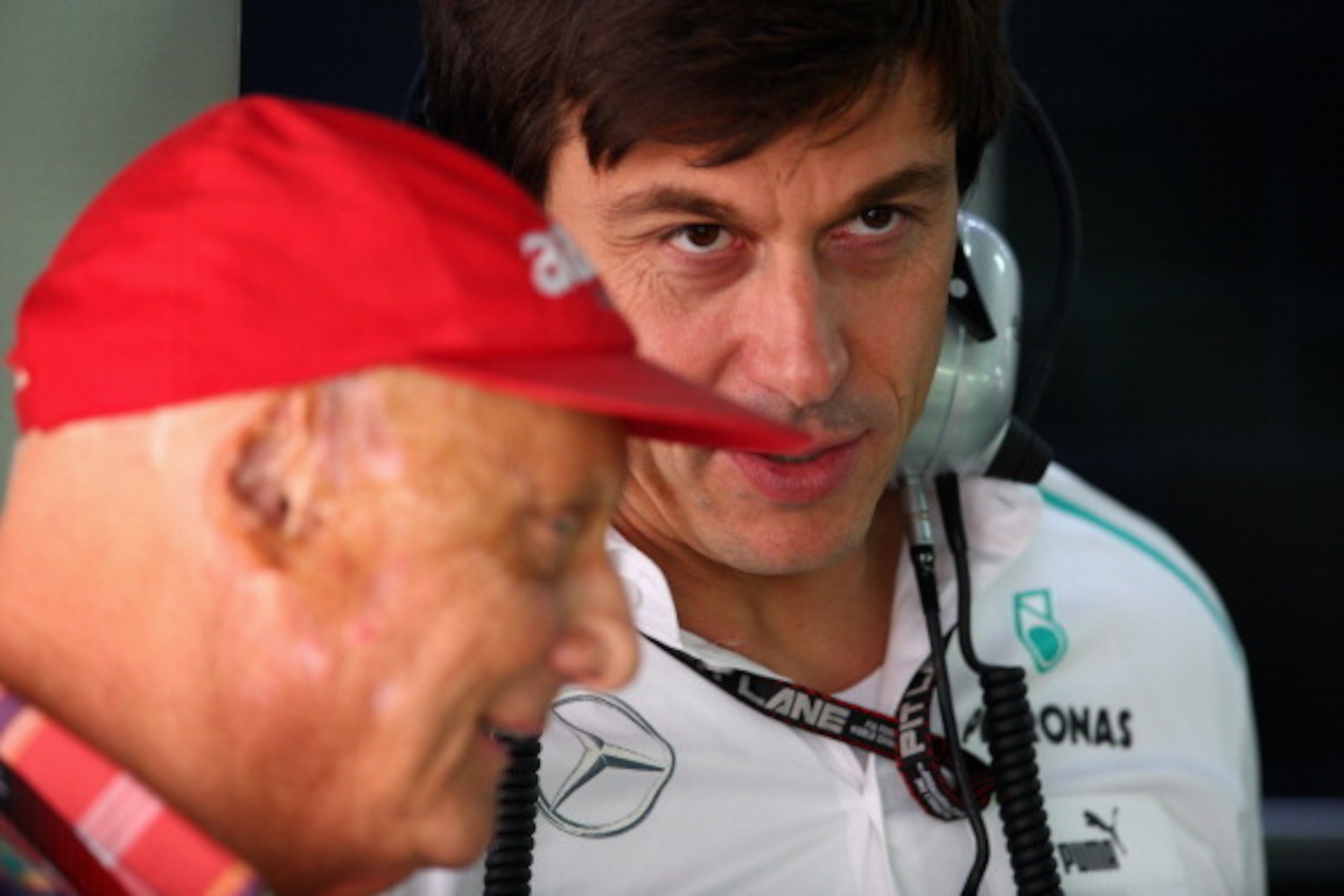 NOIDA, INDIA - OCTOBER 26:  (L-R) Niki Lauda the Non-Executive Chairman of Mercedes GP and Toto Wolff the Executive Director of Mercedes GP talk in their team garage during the final practice session prior to qualifying for the Indian Formula One Grand Pr