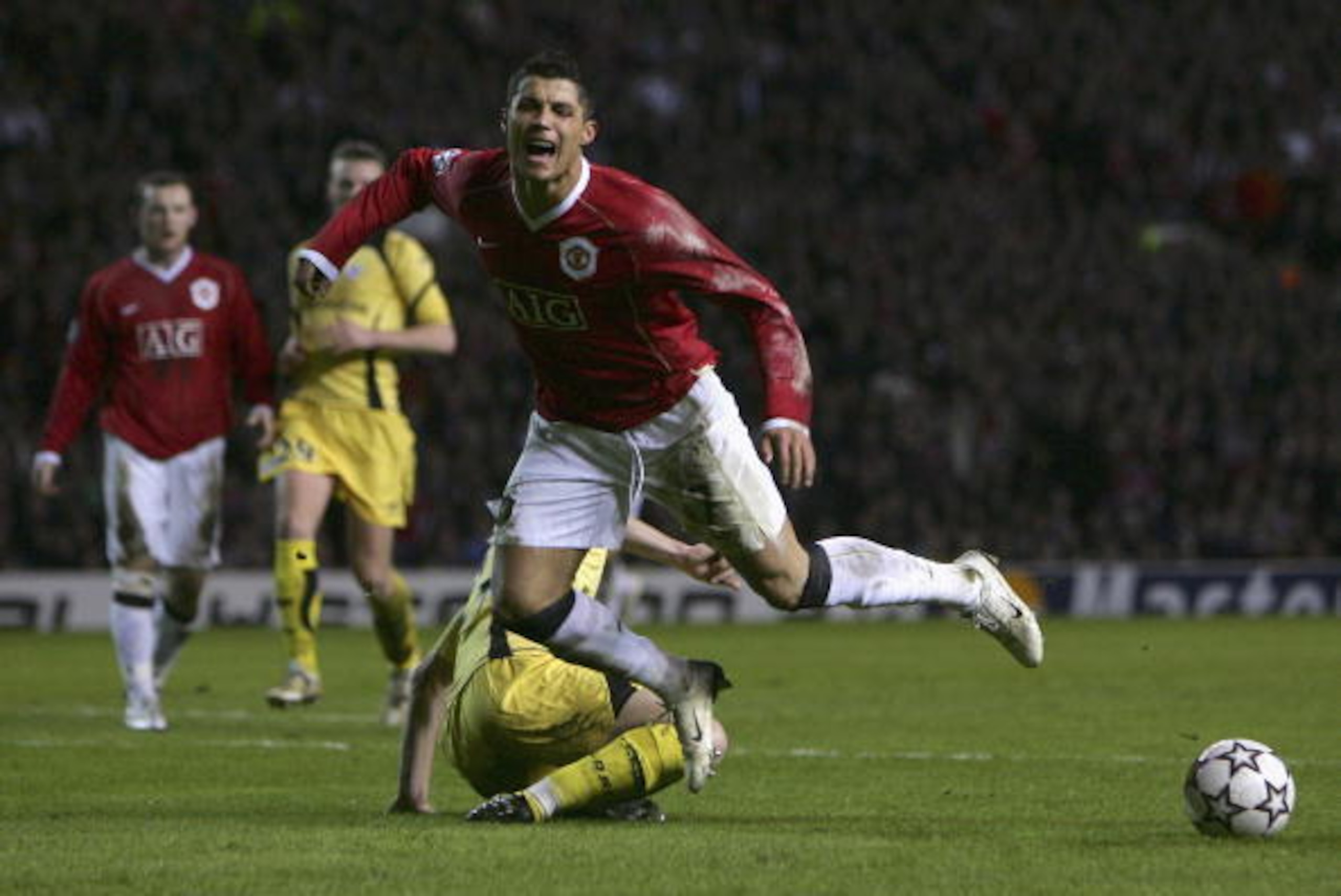 MANCHESTER, UNITED KINGDOM - MARCH 07:  Cristiano Ronaldo of Manchester United falls dramatically after being challenged by Matthieu Chalme of Lille, and is subsequently booked for diving during the UEFA Champions League round of sixteen, second leg match