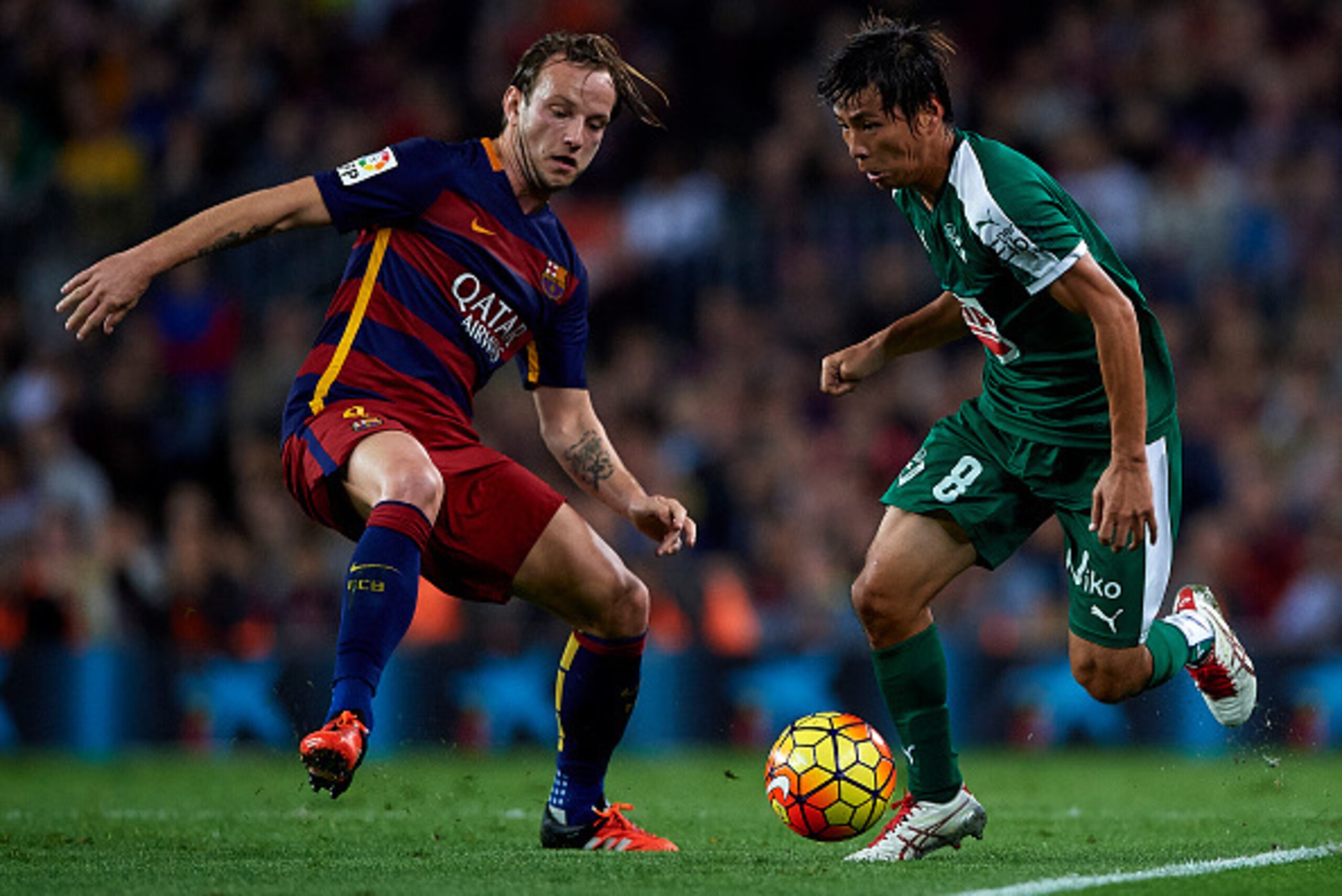 BARCELONA, SPAIN - OCTOBER 25:  Takashi Inui of Eibar runs with the ball next to Ivan Rakitic (L) of Barcelona during the La Liga match between FC Barcelona and SD Eibar at Camp Nou Stadium on October 25, 2015 in Barcelona, Spain.  (Photo by Manuel Queima