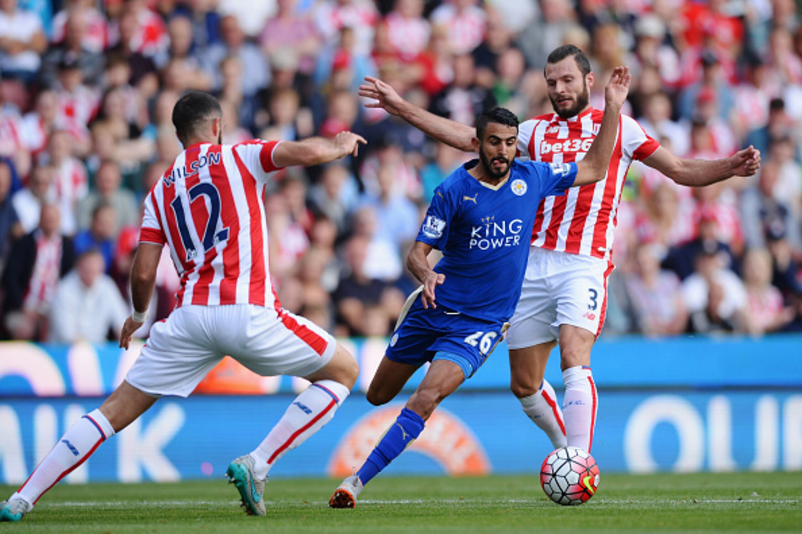 STOKE ON TRENT, ENGLAND - SEPTEMBER 19:  Riyad Mahrez of Leicester City and Marc Wilson of Stoke City compete for the ball during the Barclays Premier League match between Stoke City and Leicester City at Britannia Stadium on September 19, 2015 in Stoke o