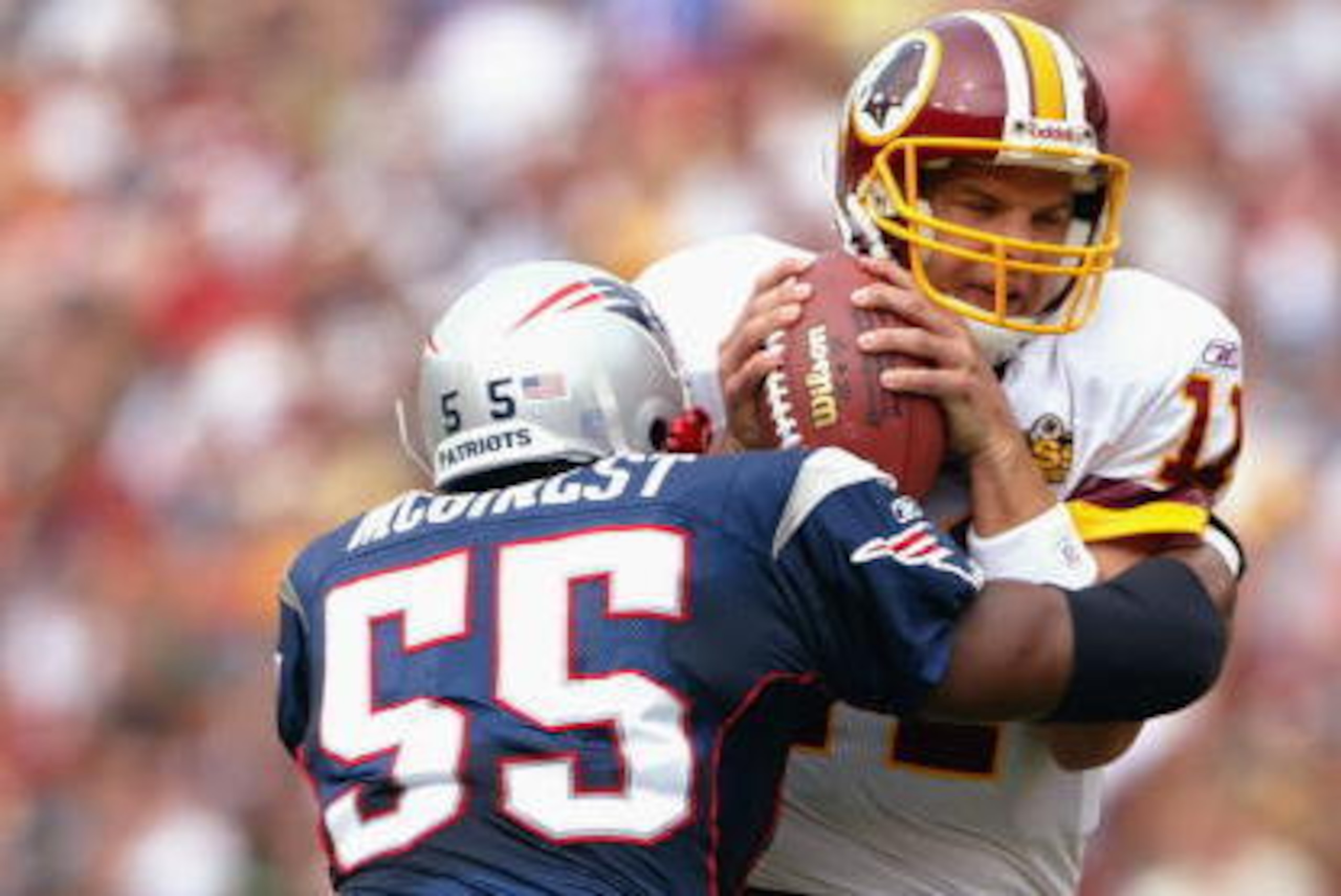 LANDOVER, MD - SEPTEMBER 28:  Quarterback Patrick Ramsey #11 of the Washington Redskins is sacked by Willie McGinest #55 of the New England Patriots on September 28, 2003 at FedEx Field in Landover, Maryland. The Redskins defeated the Patriots 20-17. (Pho