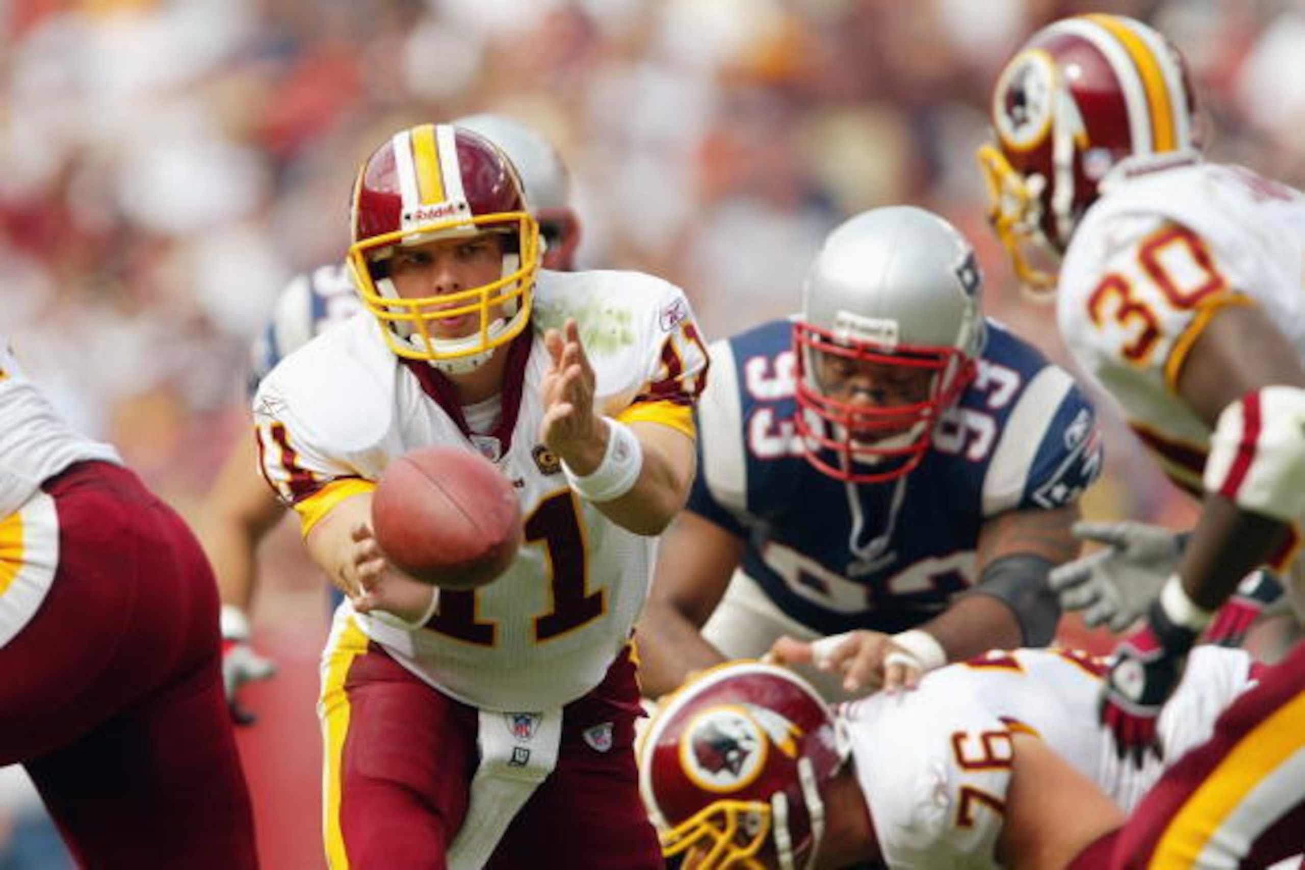 LANDOVER, MD - SEPTEMBER 28:  Quarterback Patrick Ramsey #11 of the Washington Redskins pitches the ball back to Trung Canidate #30 against the New England Patriots on September 28, 2003 at FedEx Field in Landover, Maryland. The Redskins defeated the Patr